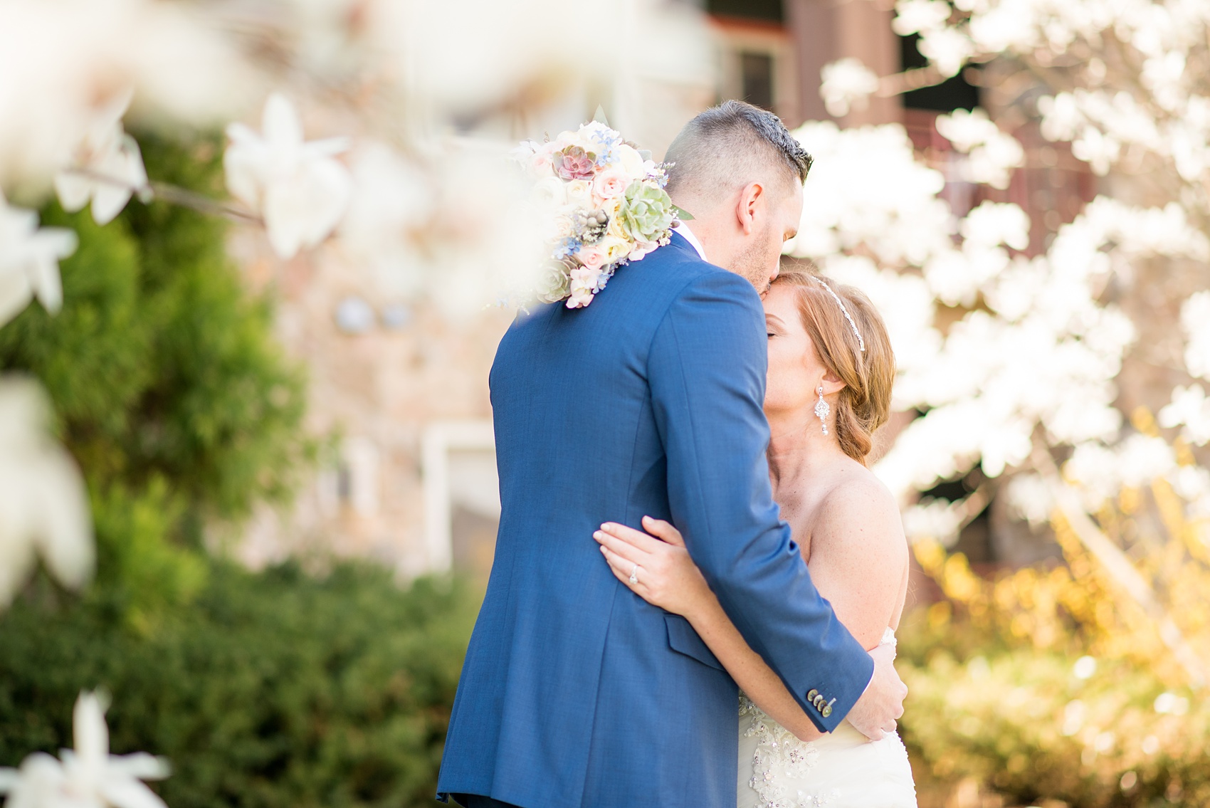 Crystal Springs Resort wedding photos in New Jersey, with photographer Mikkel Paige Photography. The couple’s spring wedding had an outdoor ceremony with photos at this rustic, woodsy venue showing their blue and pink palette decor from getting ready to their reception. This picture shows the bride and groom hugging after their first look amongst the Cherry Blossoms. Click through to see their complete wedding recap! #NewJerseywedding #MikkelPaige #NJweddingphotographer #NJphotographer #firstlook #brideandgroom #springwedding