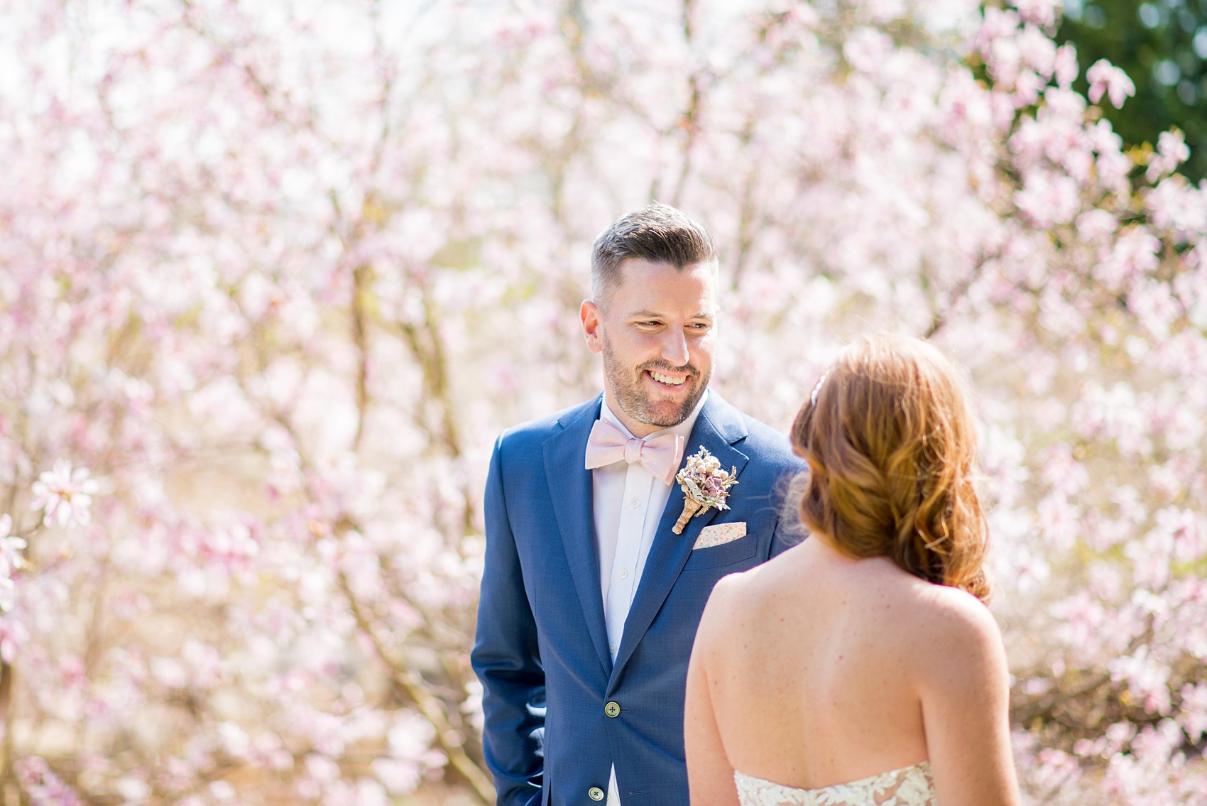 Crystal Springs Resort wedding photos in New Jersey, with photographer Mikkel Paige Photography. The couple’s spring wedding had an outdoor ceremony with photos at this rustic, woodsy venue showing their blue and pink palette decor from getting ready to their reception. This picture shows the bride and groom in her lace gown and his navy blue suit with pink bow tie. Click through to see their complete wedding recap! #NewJerseywedding #MikkelPaige #NJweddingphotographer #NJphotographer #brideandgroom #springwedding