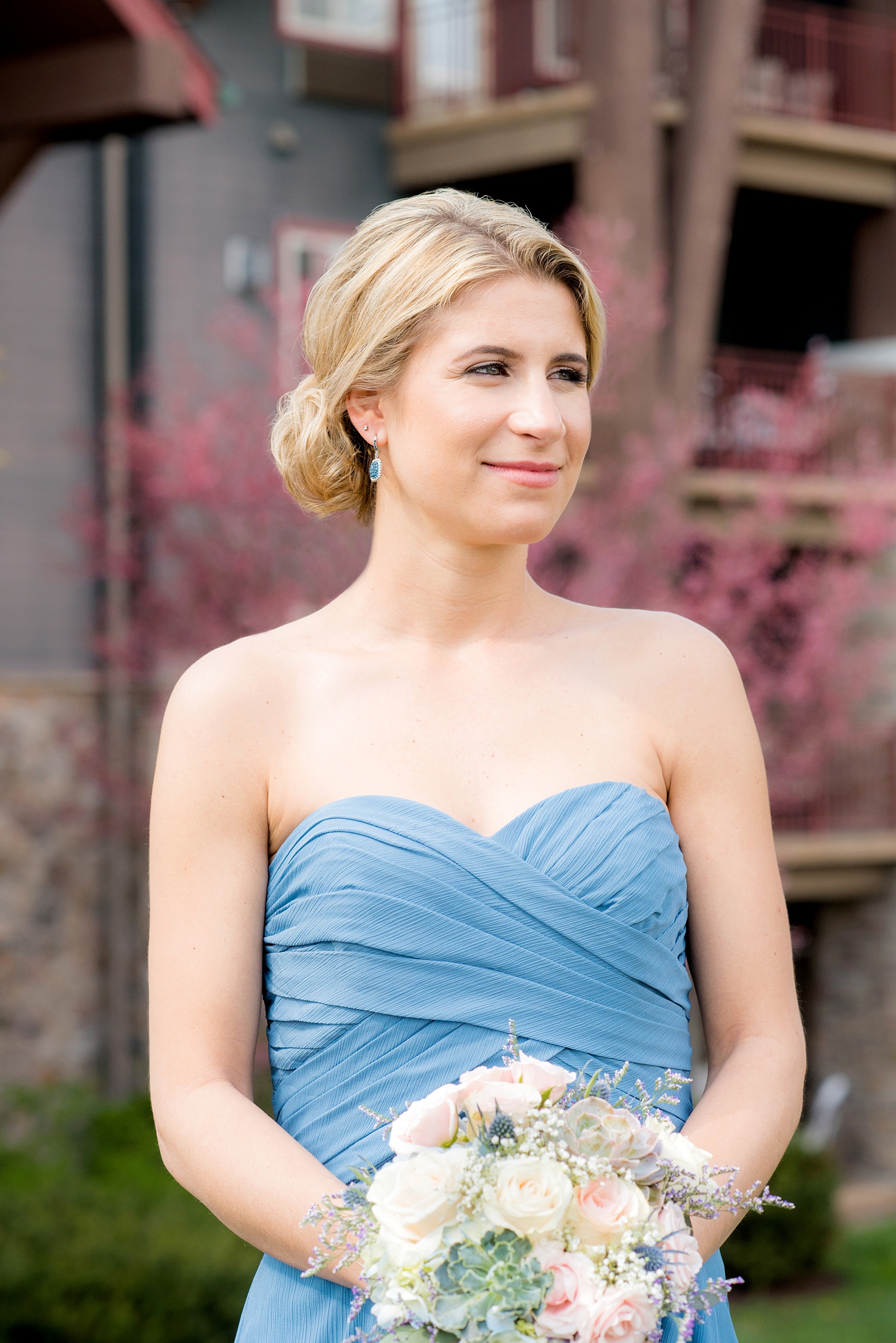 Crystal Springs Resort wedding photos in New Jersey, with photographer Mikkel Paige Photography. The couple’s spring wedding had an outdoor ceremony with photos at this rustic, woodsy venue showing their blue and pink palette decor from getting ready to their reception. This picture shows one bridesmaid in a strapless blue chiffon gown. Click through to see their complete wedding recap! #NewJerseywedding #MikkelPaige #NJweddingphotographer #NJphotographer #brideandgroom #springwedding #mismatchedgowns #pinkandblue #weddingparty #bridalparty