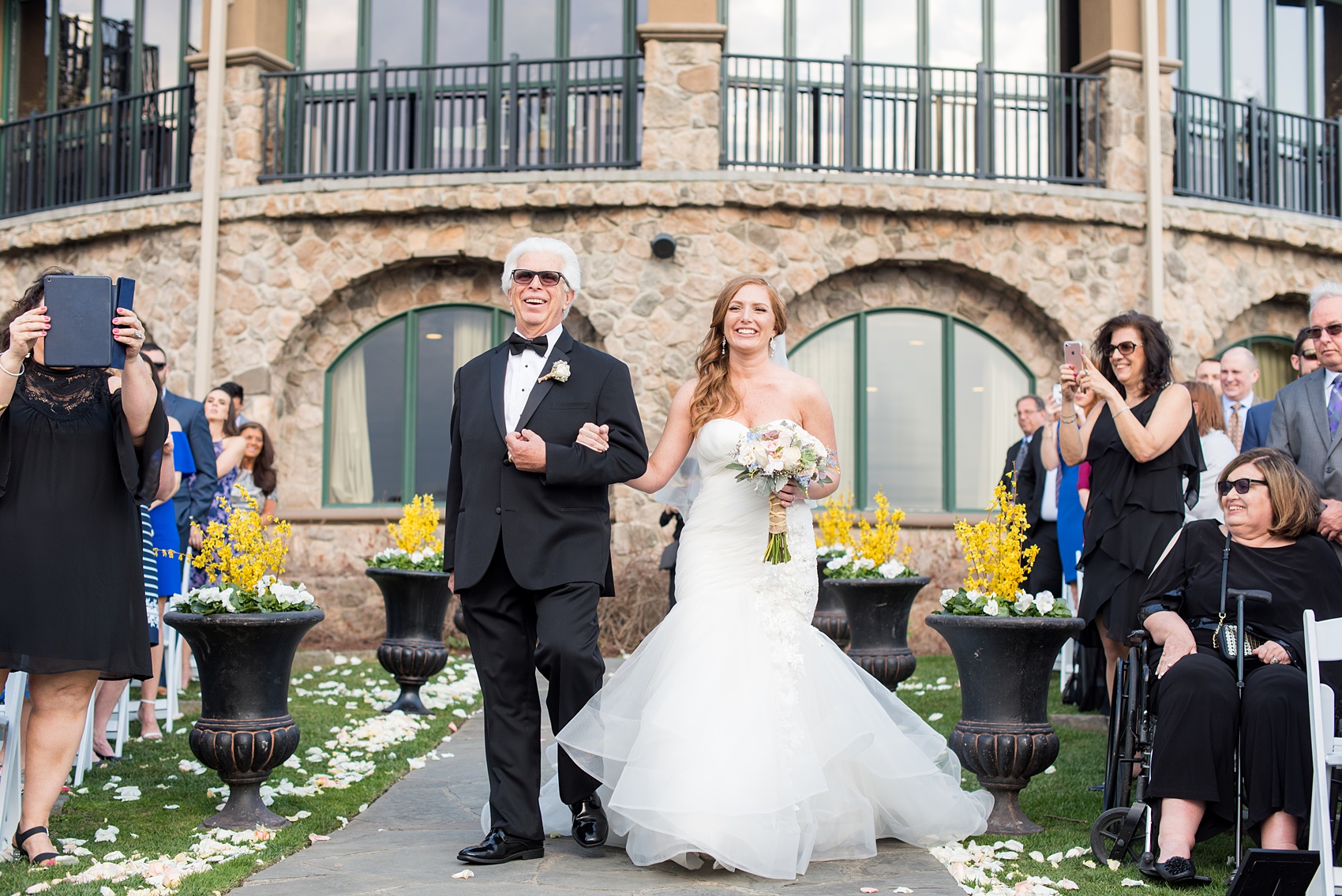 Crystal Springs Resort wedding photos in New Jersey, with photographer Mikkel Paige Photography. The couple’s spring wedding had an outdoor ceremony with photos at this rustic, woodsy venue showing their blue and pink palette decor from getting ready to their reception. This photo shows the father of the bride walking his daughter down the aisle. Click through to see their complete wedding recap! #NewJerseywedding #MikkelPaige #NJweddingphotographer #NJphotographer #springwedding #pinkandblue #outdoorceremony #herecomesthebride #fatherofthebride