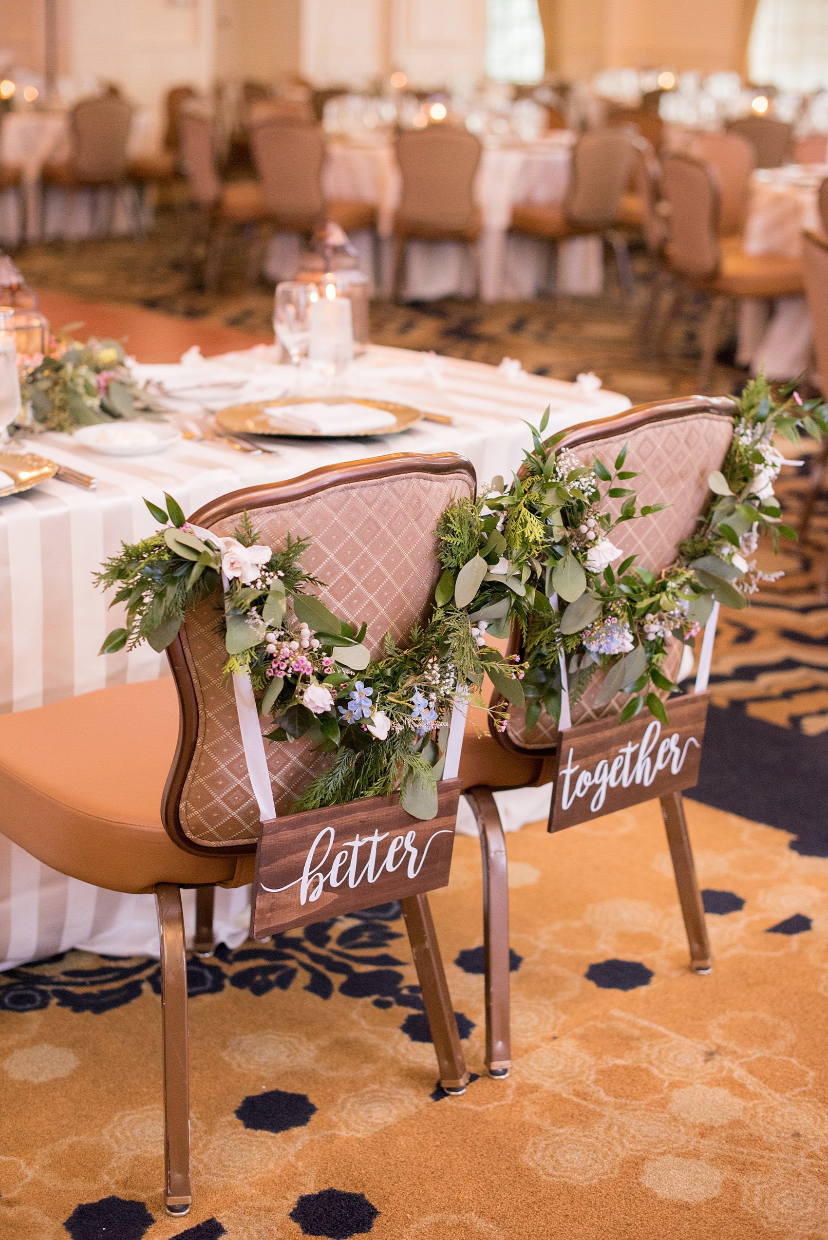 Crystal Springs Resort wedding photos in New Jersey, with photographer Mikkel Paige Photography. The couple’s spring wedding had an outdoor ceremony with photos at this rustic, woodsy venue showing their blue and pink palette decor from getting ready to their reception. This detail picture shows the bride and groom's reception chairs with custom wooden "better together" signs and floral swags. Click through to see their complete wedding recap! #NewJerseywedding #MikkelPaige #NJweddingphotographer #NJphotographer #springwedding #pinkandblue #receptionchairs #floralswags #brideandgroomchairs