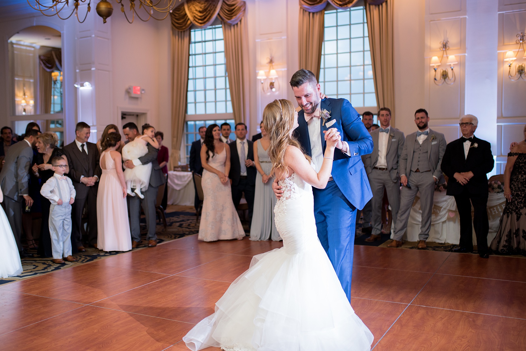 Crystal Springs Resort wedding photos in New Jersey, with photographer Mikkel Paige Photography. The couple’s spring wedding had an outdoor ceremony with photos at this rustic, woodsy venue showing their blue and pink palette decor from getting ready to their reception. This picture shows the bride and groom dancing their first dance. Click through to see their complete wedding recap! #NewJerseywedding #MikkelPaige #NJweddingphotographer #NJphotographer #springwedding #pinkandblue #escortcards #escortcardtable