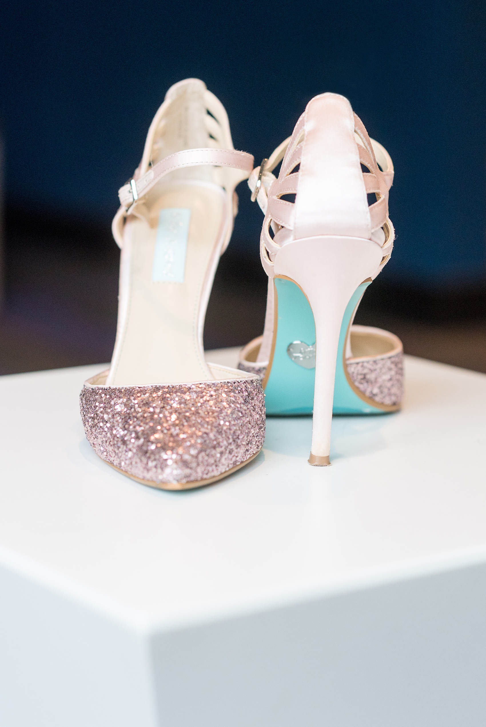 The Rickhouse wedding photos by Mikkel Paige photography in Durham, North Carolina. This urban venue has all the charm of the south for this bride and groom's spring wedding! This detail picture shows the bride's rose gold glitter blue-sole Betsy Johnson heels. #mikkelpaige #northcarolina #southernwedding #TheRickhouseDurham #rosegoldandpink