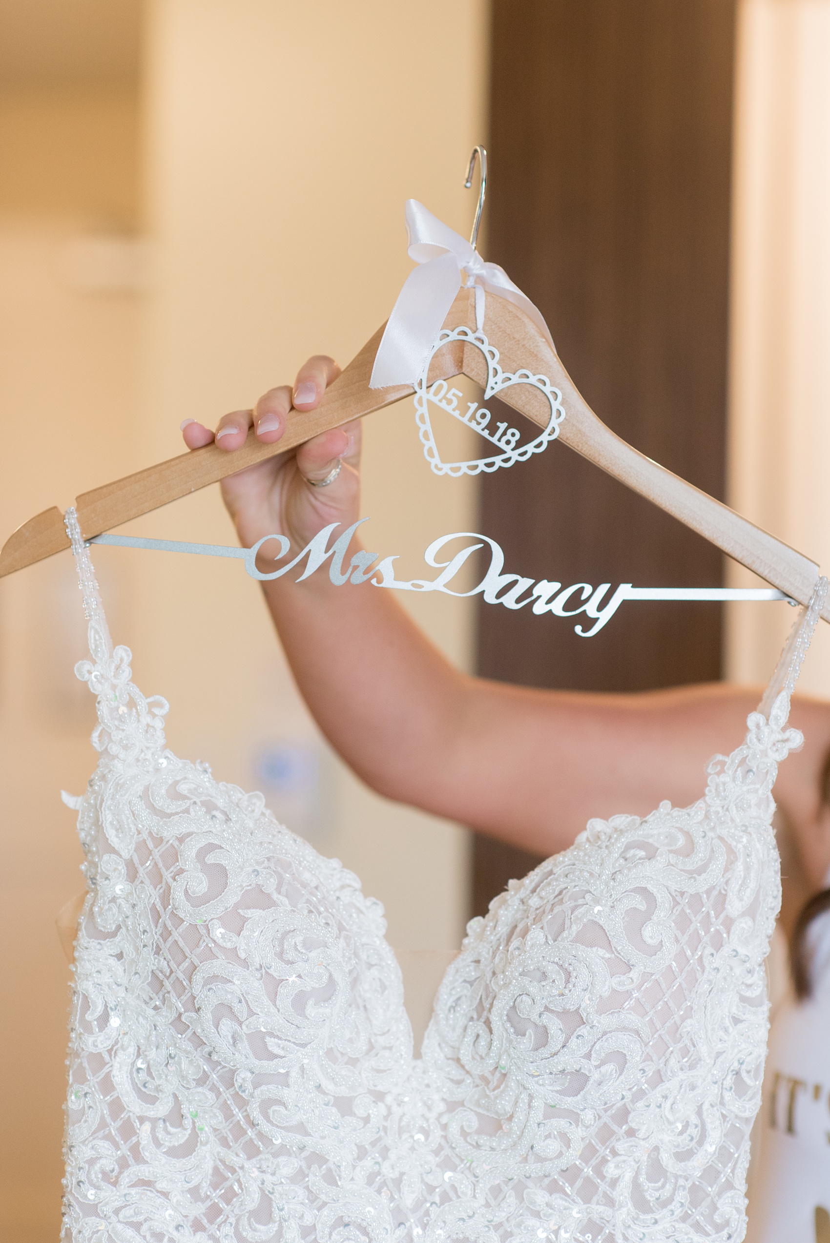 The Rickhouse wedding photos by Mikkel Paige photography in Durham, North Carolina. This urban venue has all the charm of the south for this bride and groom's spring wedding! This detail picture shows the bride's custom hanger with their wedding date. #mikkelpaige #northcarolina #southernwedding #TheRickhouseDurham #rosegoldandpink