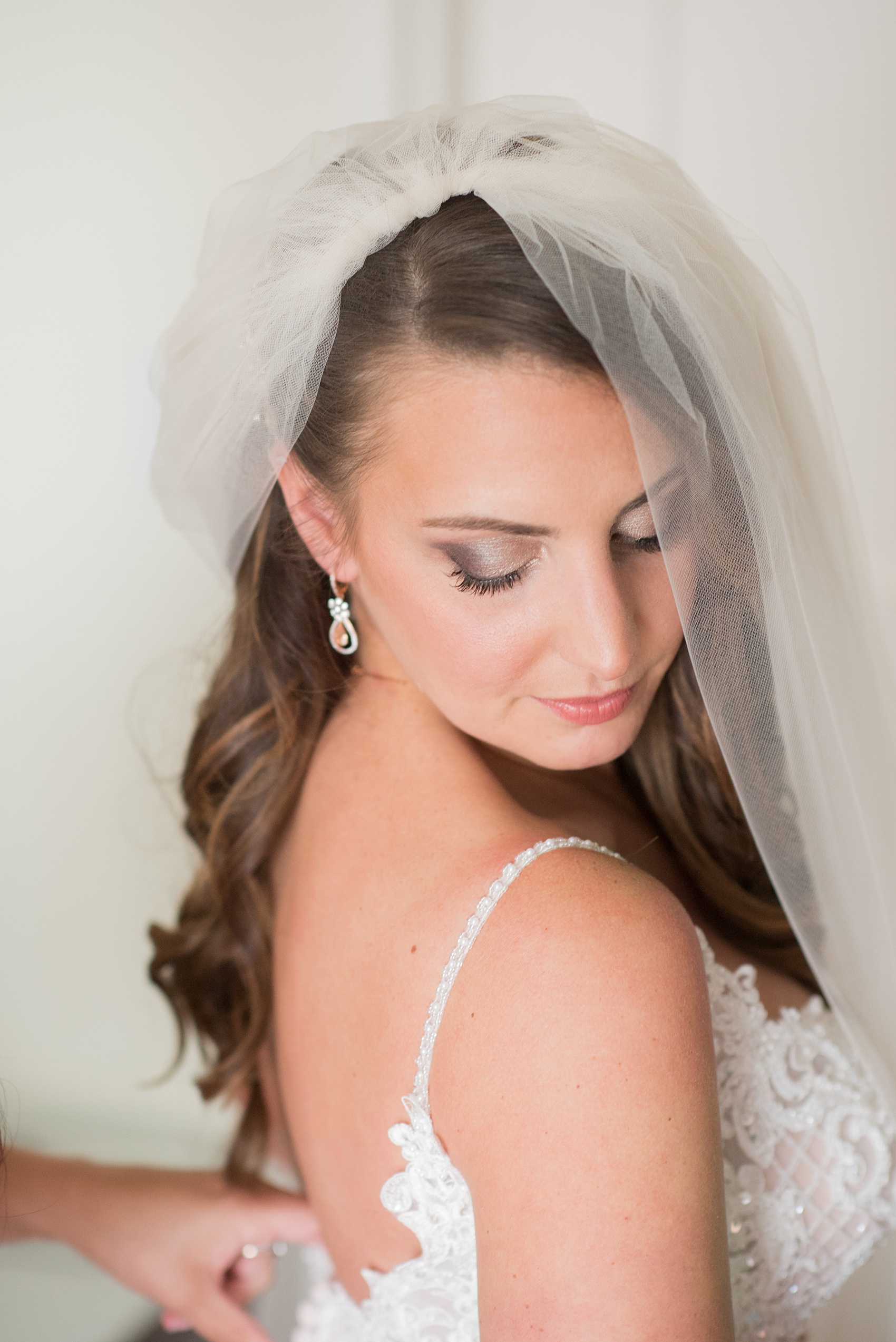 The Rickhouse wedding photos by Mikkel Paige photography in Durham, North Carolina. This urban venue has all the charm of the south for this bride and groom's spring wedding! This picture shows the bride getting ready in the hotel on her day! Click through to see the complete post! #mikkelpaige #northcarolina #southernwedding #TheRickhouseDurham #rosegoldandpink