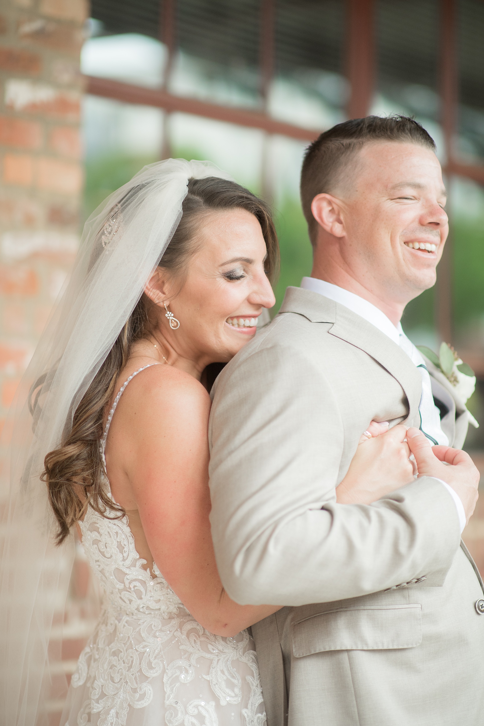 The Rickhouse wedding photos by Mikkel Paige photography in Durham, North Carolina. This urban venue has all the charm of the south for this bride and groom's spring wedding! This picture shows the bride and groom at American Tobacco Campus right after their first look. Click to see more from their day! #mikkelpaige #northcarolina #southernwedding #TheRickhouseDurham #rosegoldandpink #brideandgroom