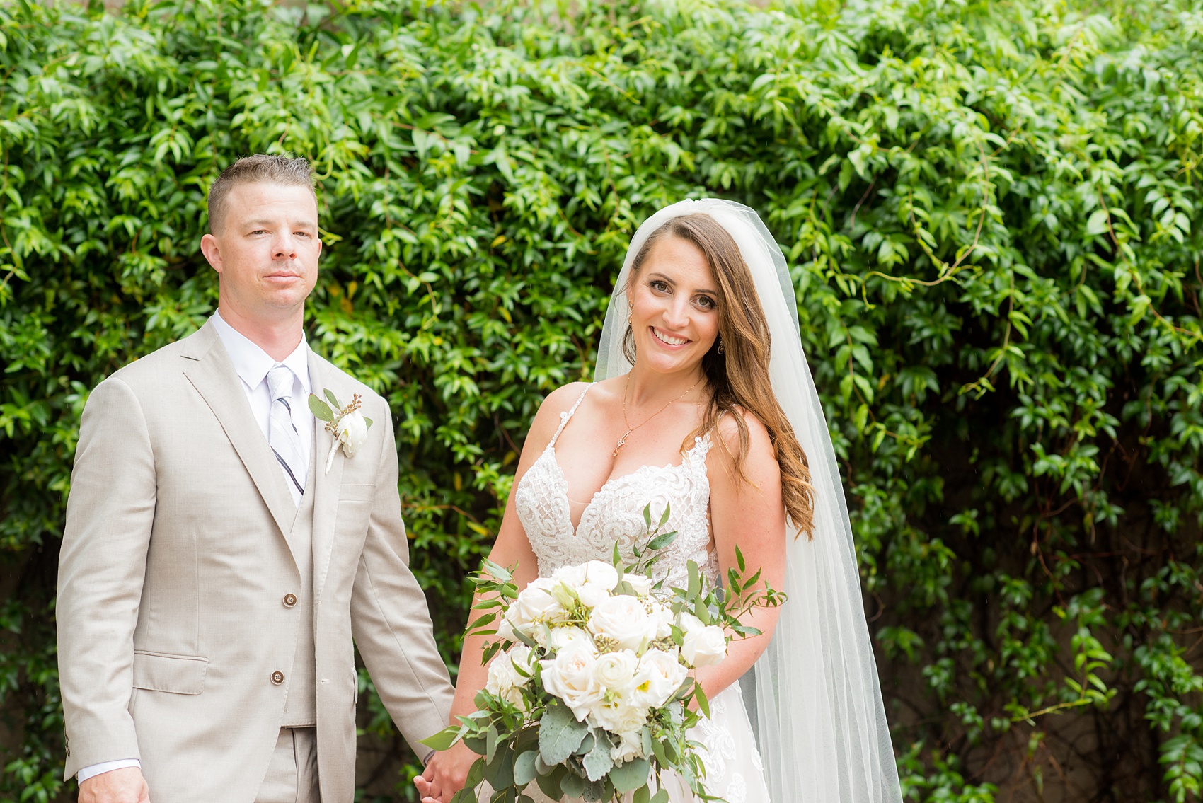 The Rickhouse wedding photos by Mikkel Paige photography in Durham, North Carolina. This urban venue has all the charm of the south for this bride and groom's spring wedding! This picture shows the bride and groom at American Tobacco Campus against a gorgeous wall of green ivy. Click to see more from their day! #mikkelpaige #northcarolina #southernwedding #TheRickhouseDurham #rosegoldandpink #brideandgroom