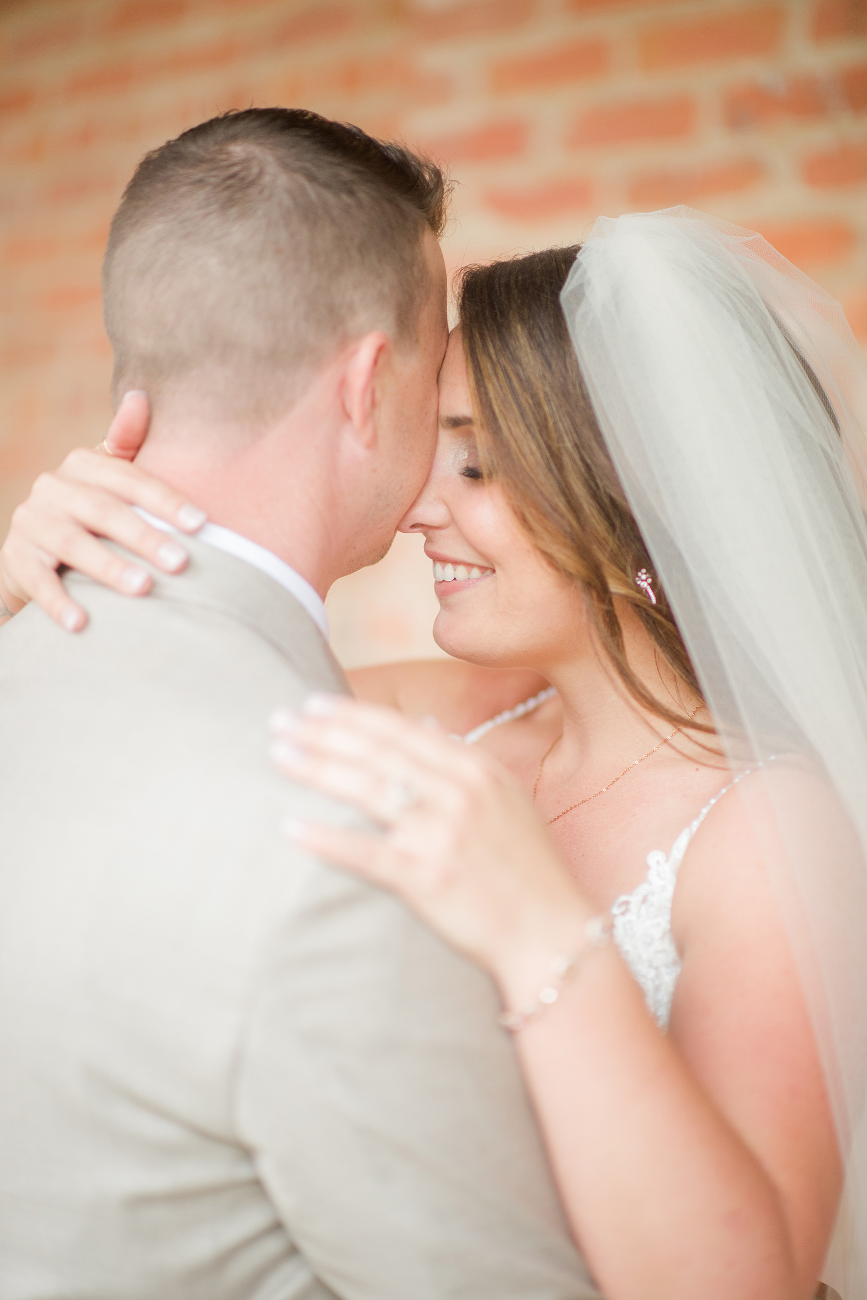 The Rickhouse wedding photos by Mikkel Paige photography in Durham, North Carolina. This urban venue has all the charm of the south for this bride and groom's spring wedding! This picture shows the bride and groom at American Tobacco Campus right after their first look. Click to see more from their day! #mikkelpaige #northcarolina #southernwedding #TheRickhouseDurham #rosegoldandpink #brideandgroom