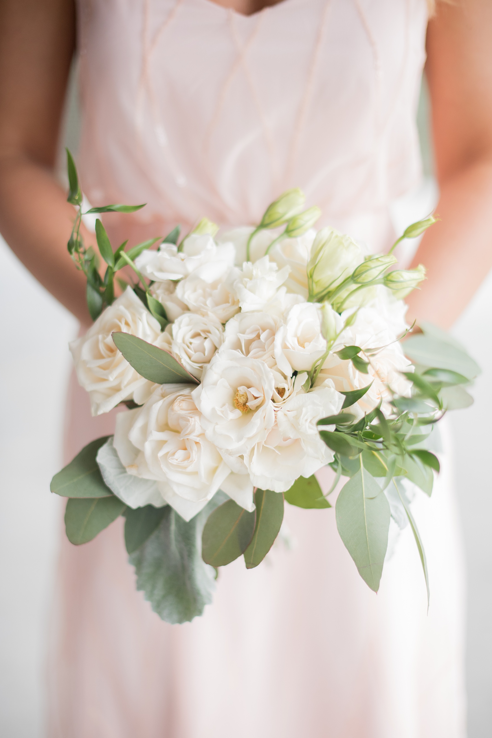 The Rickhouse wedding photos by Mikkel Paige photography in Durham, North Carolina. This urban venue has all the charm of the south for this bride and groom's spring wedding! This picture shows the white bridesmaid bouquet with roses and eucalyptus. Click to see more from their day! #mikkelpaige #northcarolina #southernwedding #TheRickhouseDurham #rosegoldandpink #bridesmaidbouquet #whitebouquet 