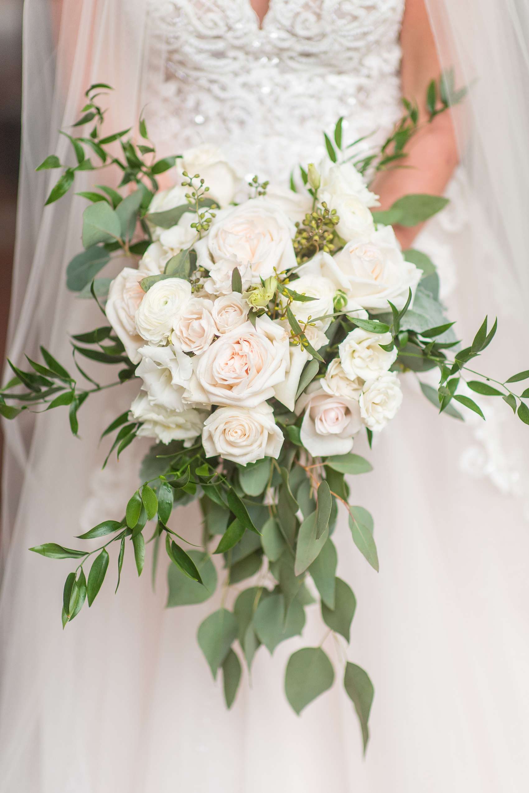 The Rickhouse wedding photos by Mikkel Paige photography in Durham, North Carolina. This urban venue has all the charm of the south for this bride and groom's spring wedding! This picture shows the white slightly cascading bridal bouquet with roses and eucalyptus. Click to see more from their day! #mikkelpaige #northcarolina #southernwedding #TheRickhouseDurham #rosegoldandpink #bridalbouquet #whitebouquet 