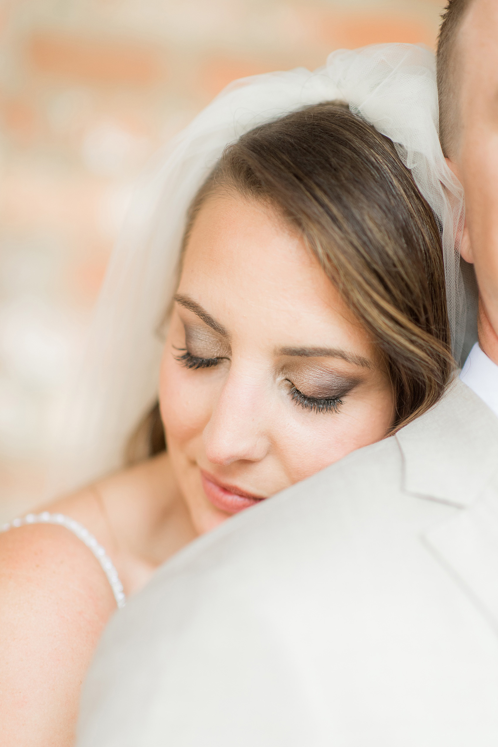 The Rickhouse wedding photos by Mikkel Paige photography in Durham, North Carolina. This urban venue has all the charm of the south for this bride and groom's spring wedding! This picture shows the bride leaning on her groom with her beautiful makeup. Click to see more from their day! #mikkelpaige #northcarolina #southernwedding #TheRickhouseDurham #rosegoldandpink #bride 