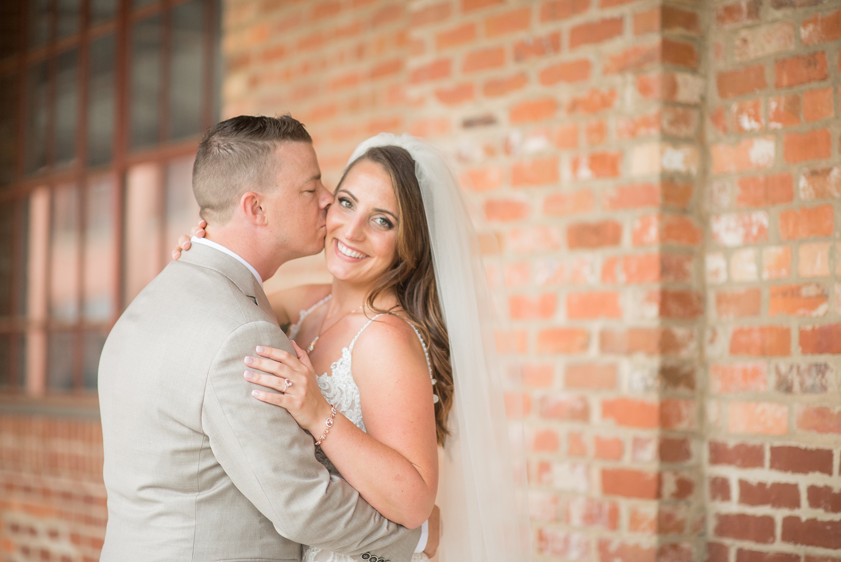 The Rickhouse wedding photos by Mikkel Paige photography in Durham, North Carolina. This urban venue has all the charm of the south for this bride and groom's spring wedding! This picture shows the bridal party posing for a photo with pink gowns and white bouquets at American Tobacco Campus. Click to see more from their day! #mikkelpaige #northcarolina #southernwedding #TheRickhouseDurham #rosegoldandpink #rainywedding #weddingintherain #bridalparty #pinkbridesmaids 