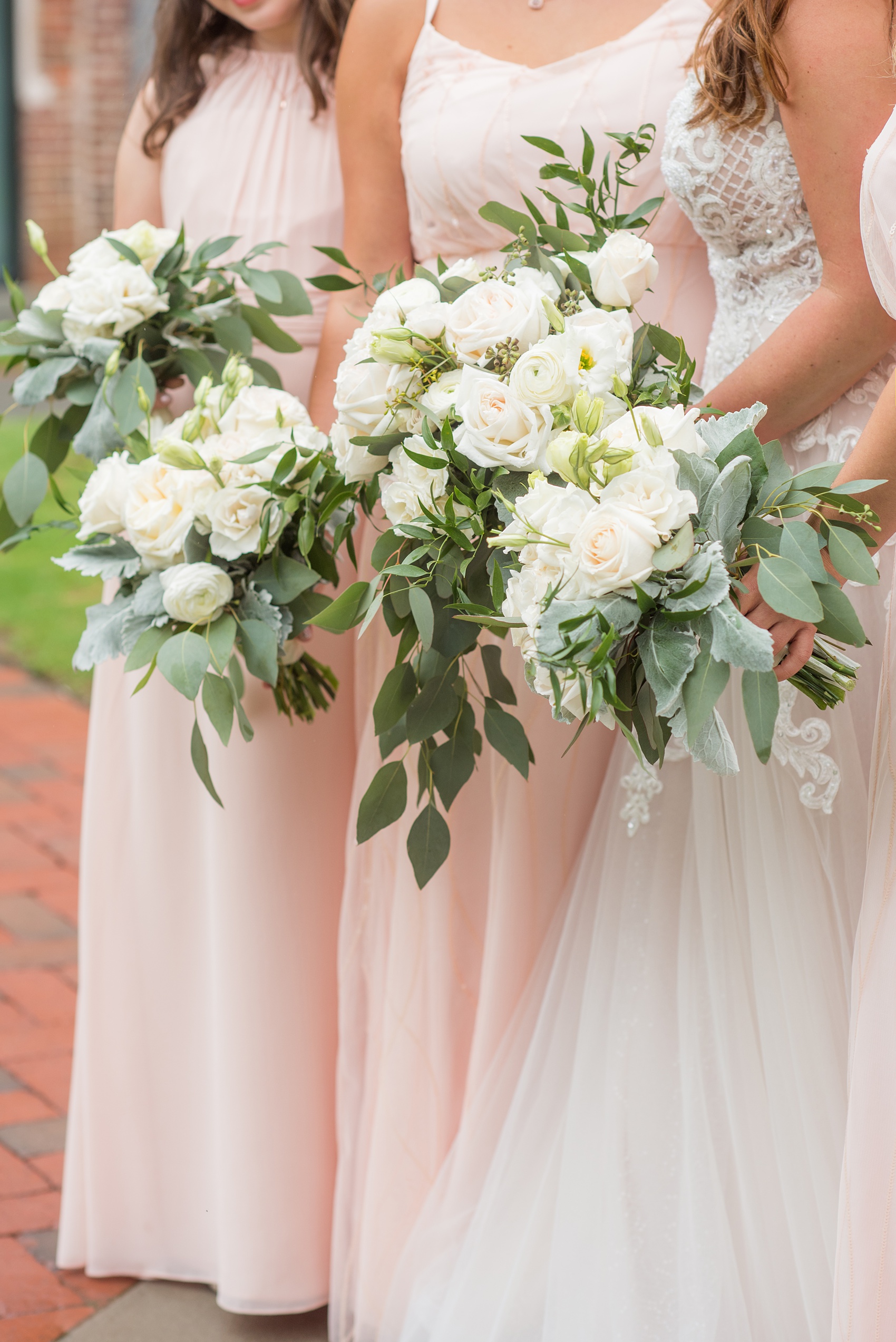 The Rickhouse wedding photos by Mikkel Paige photography in Durham, North Carolina. This urban venue has all the charm of the south for this bride and groom's spring wedding! This picture shows the bridal party posing for a photo with pink gowns and white bouquets at American Tobacco Campus. Click to see more from their day! #mikkelpaige #northcarolina #southernwedding #TheRickhouseDurham #rosegoldandpink #rainywedding #weddingintherain #bridalparty #pinkbridesmaids 