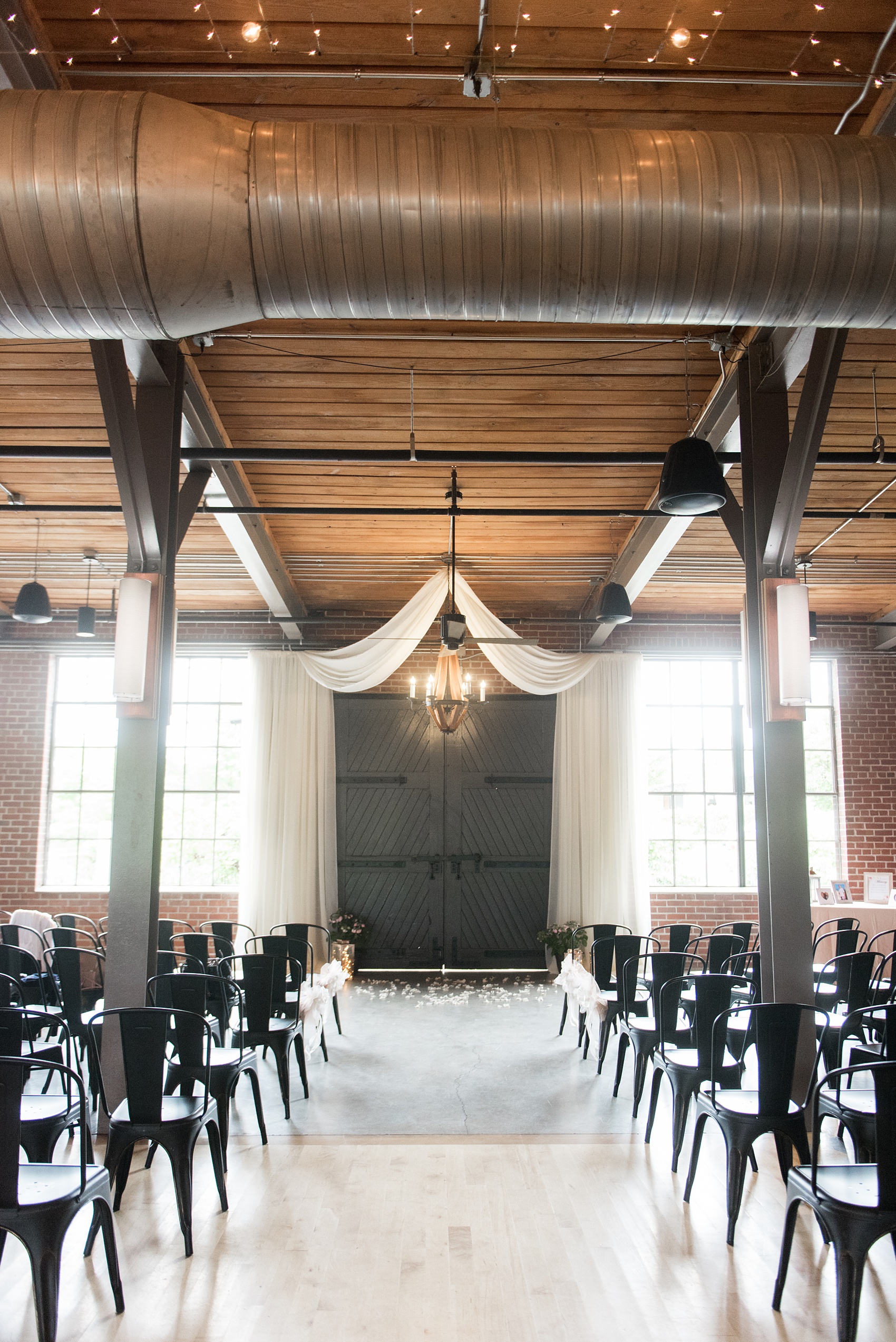 The Rickhouse wedding photos by Mikkel Paige photography in Durham, North Carolina. This urban venue has all the charm of the south for this bride and groom's spring wedding! The bride and groom had an indoor ceremony with white draping. Click to see more from their day! #mikkelpaige #northcarolina #southernwedding #TheRickhouseDurham #rosegoldandpink #weddingceremony #indoorceremony