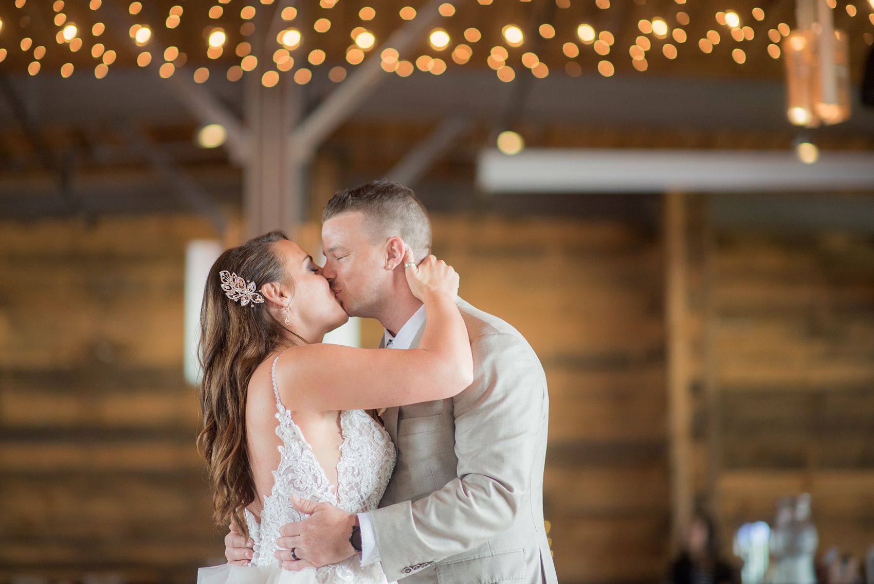 The Rickhouse wedding photos by Mikkel Paige photography in Durham, North Carolina. This urban venue has all the charm of the south for this bride and groom's spring wedding! This picture shows the couple kissing under market lights after their first dance. Click to see more from their day! #mikkelpaige #northcarolina #southernwedding #TheRickhouseDurham #rosegoldandpink 