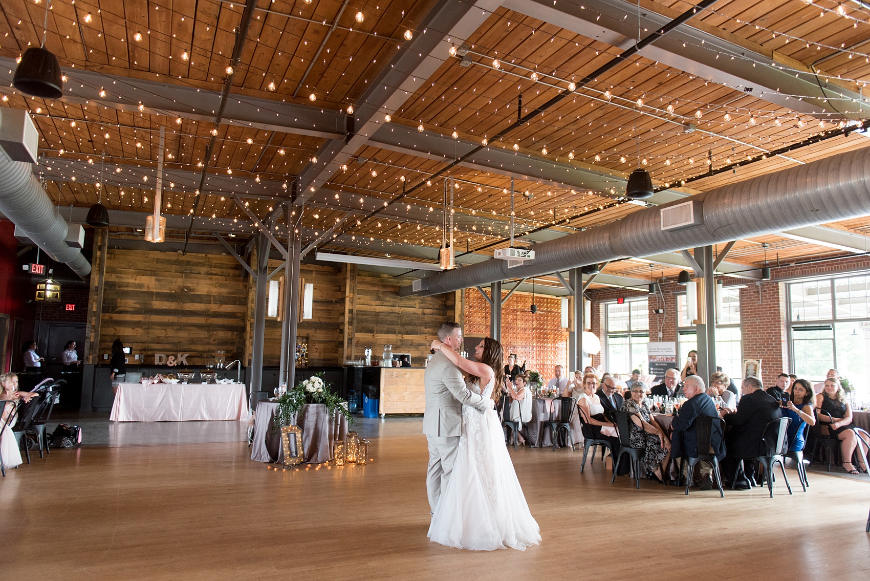 The Rickhouse wedding photos by Mikkel Paige photography in Durham, North Carolina. This urban venue has all the charm of the south for this bride and groom's spring wedding! This picture shows the couple under market lights during see more from their day! #mikkelpaige #northcarolina #southernwedding #TheRickhouseDurham #rosegoldandpink 