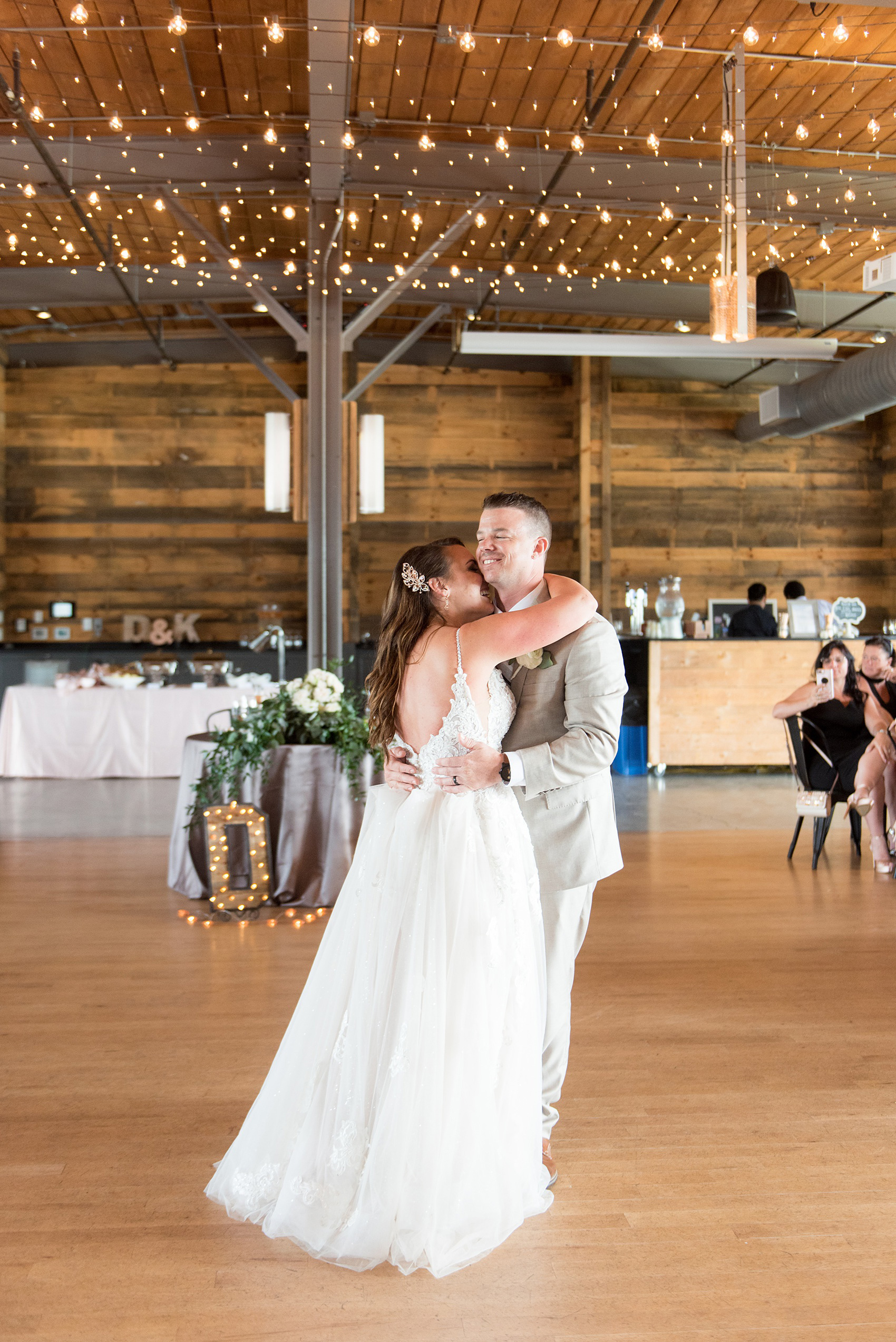 The Rickhouse wedding photos by Mikkel Paige photography in Durham, North Carolina. This urban venue has all the charm of the south for this bride and groom's spring wedding! This picture shows the couple under market lights during see more from their day! #mikkelpaige #northcarolina #southernwedding #TheRickhouseDurham #rosegoldandpink 