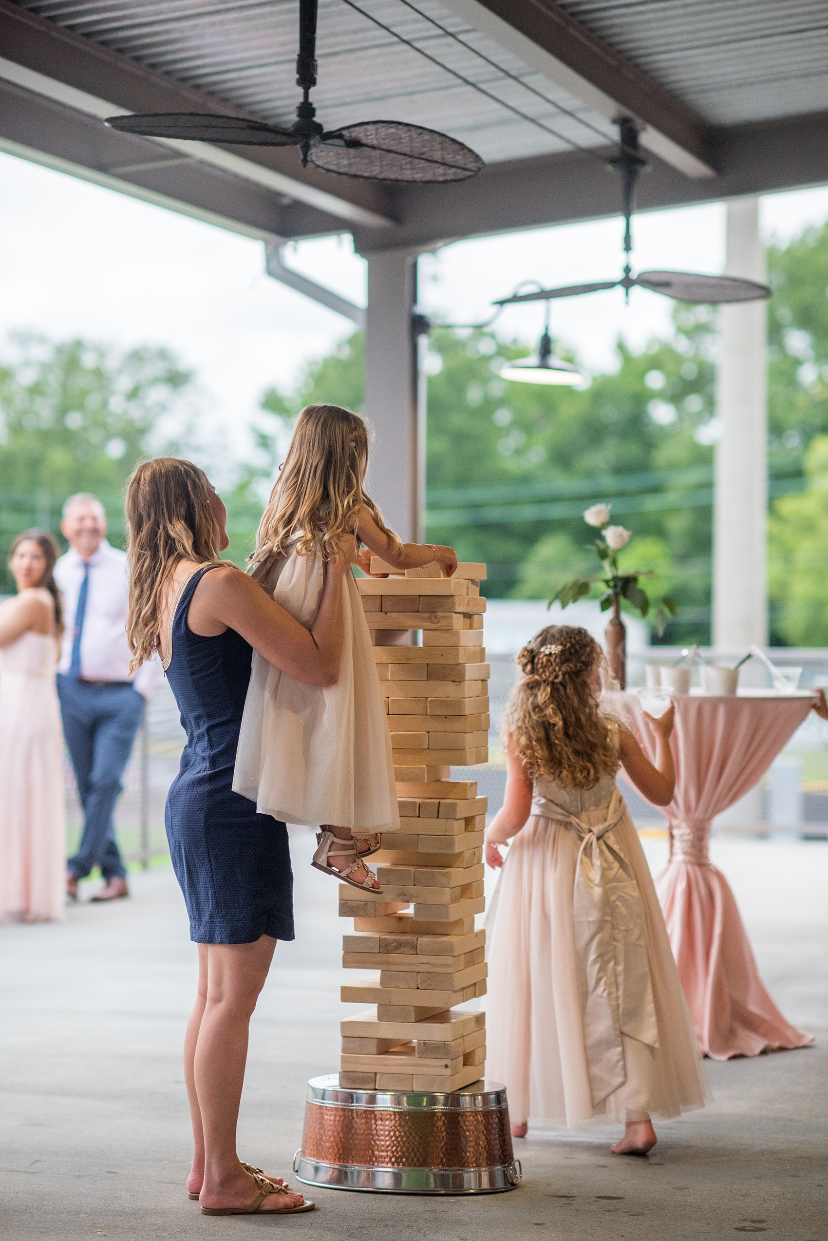 The Rickhouse wedding photos by Mikkel Paige photography in Durham, North Carolina. This urban venue has all the charm of the south for this bride and groom's spring wedding! The couple got engaged after a game of Jenga, so they had a huge Jenga to play at the wedding! Click through to see more gorgeous details from their day. #mikkelpaige #northcarolina #southernwedding #TheRickhouseDurham #rosegoldandpink