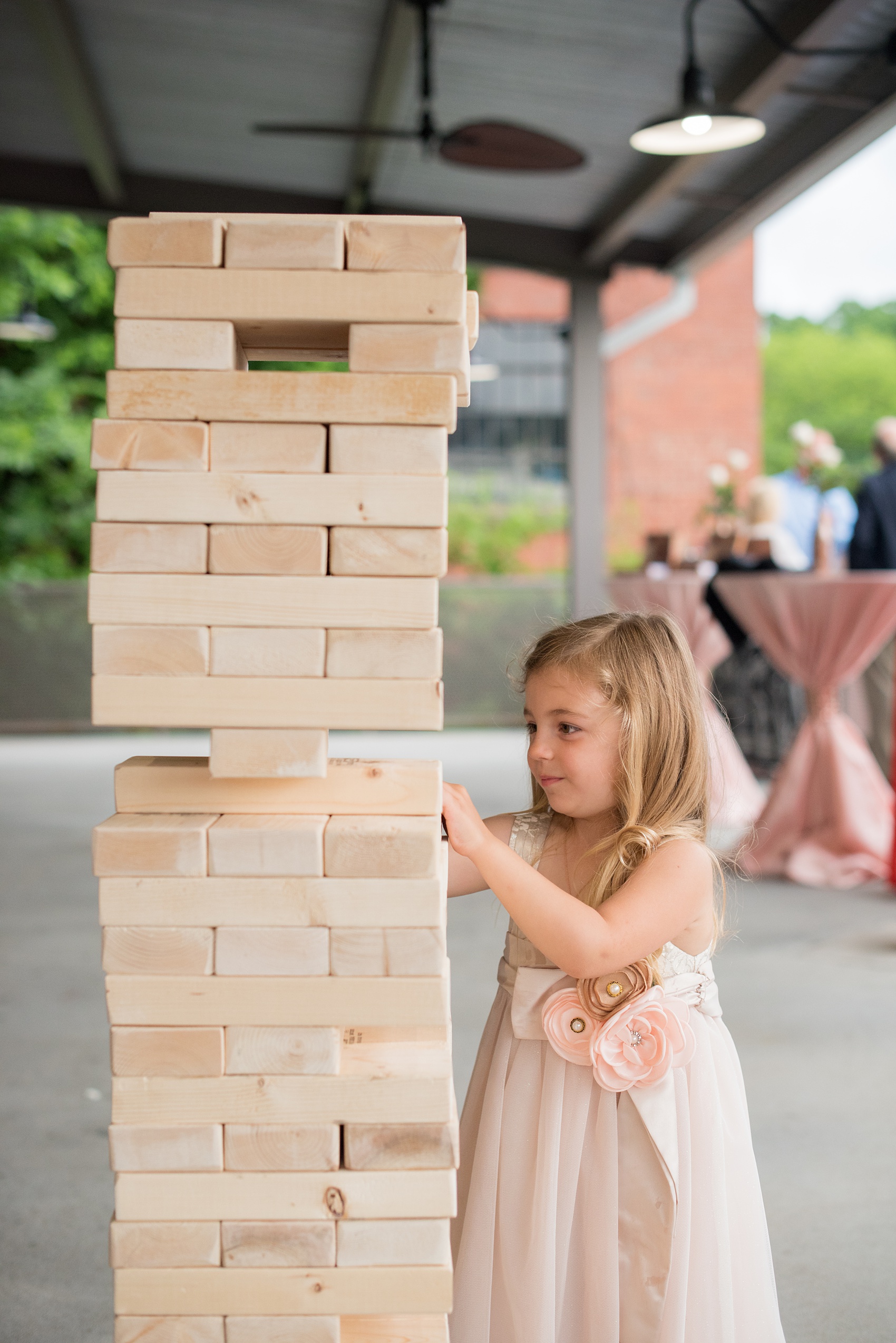 The Rickhouse wedding photos by Mikkel Paige photography in Durham, North Carolina. This urban venue has all the charm of the south for this bride and groom's spring wedding! The couple got engaged after a game of Jenga, so they had a huge Jenga to play at the wedding! Click through to see more gorgeous details from their day. #mikkelpaige #northcarolina #southernwedding #TheRickhouseDurham #rosegoldandpink