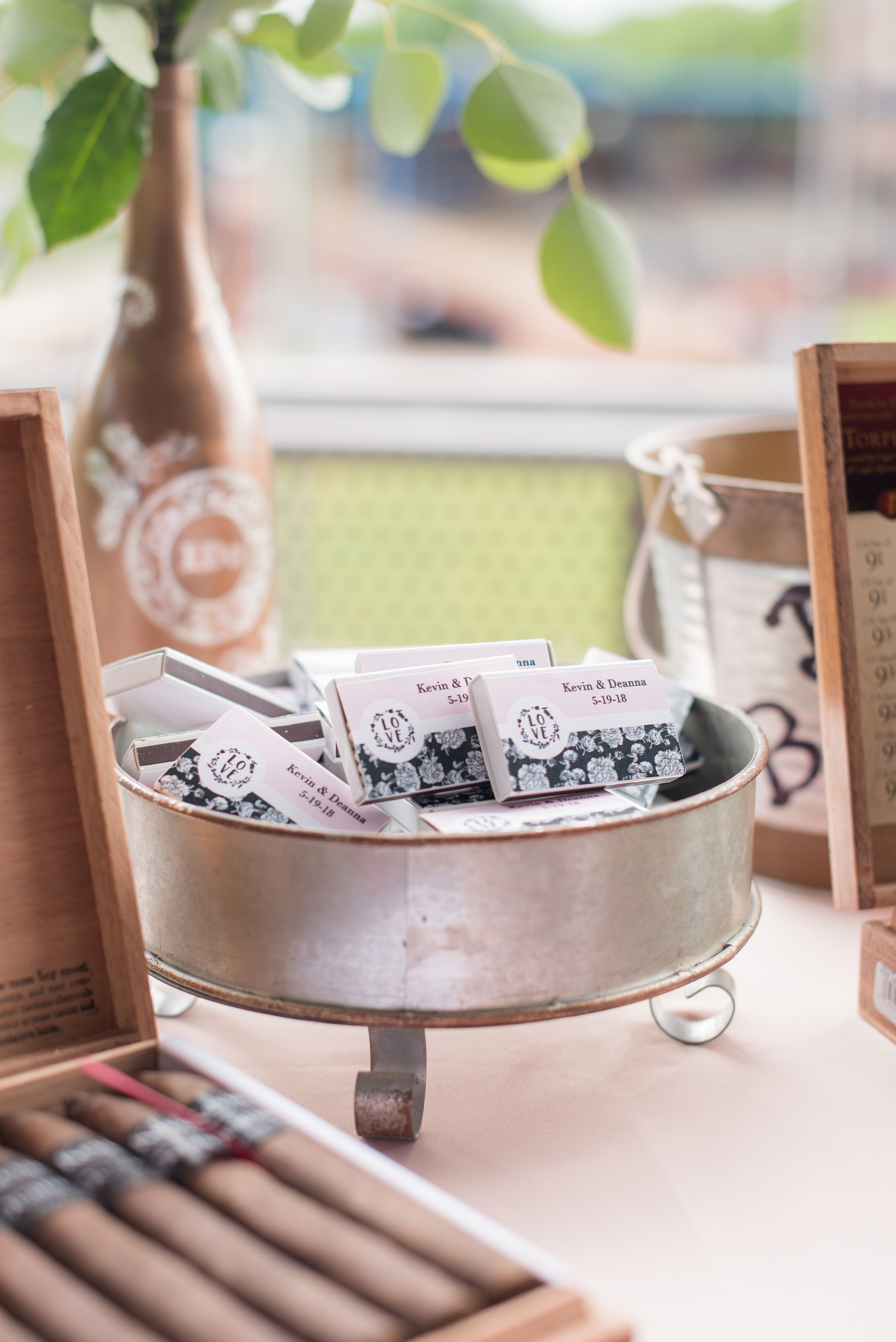 The Rickhouse wedding photos by Mikkel Paige photography in Durham, North Carolina. This urban venue has all the charm of the south for this bride and groom's spring wedding! This picture shows their cigar bar with custom labels and matches. Click through to see more gorgeous details from their day. #mikkelpaige #northcarolina #southernwedding #TheRickhouseDurham #rosegoldandpink #cigarbar