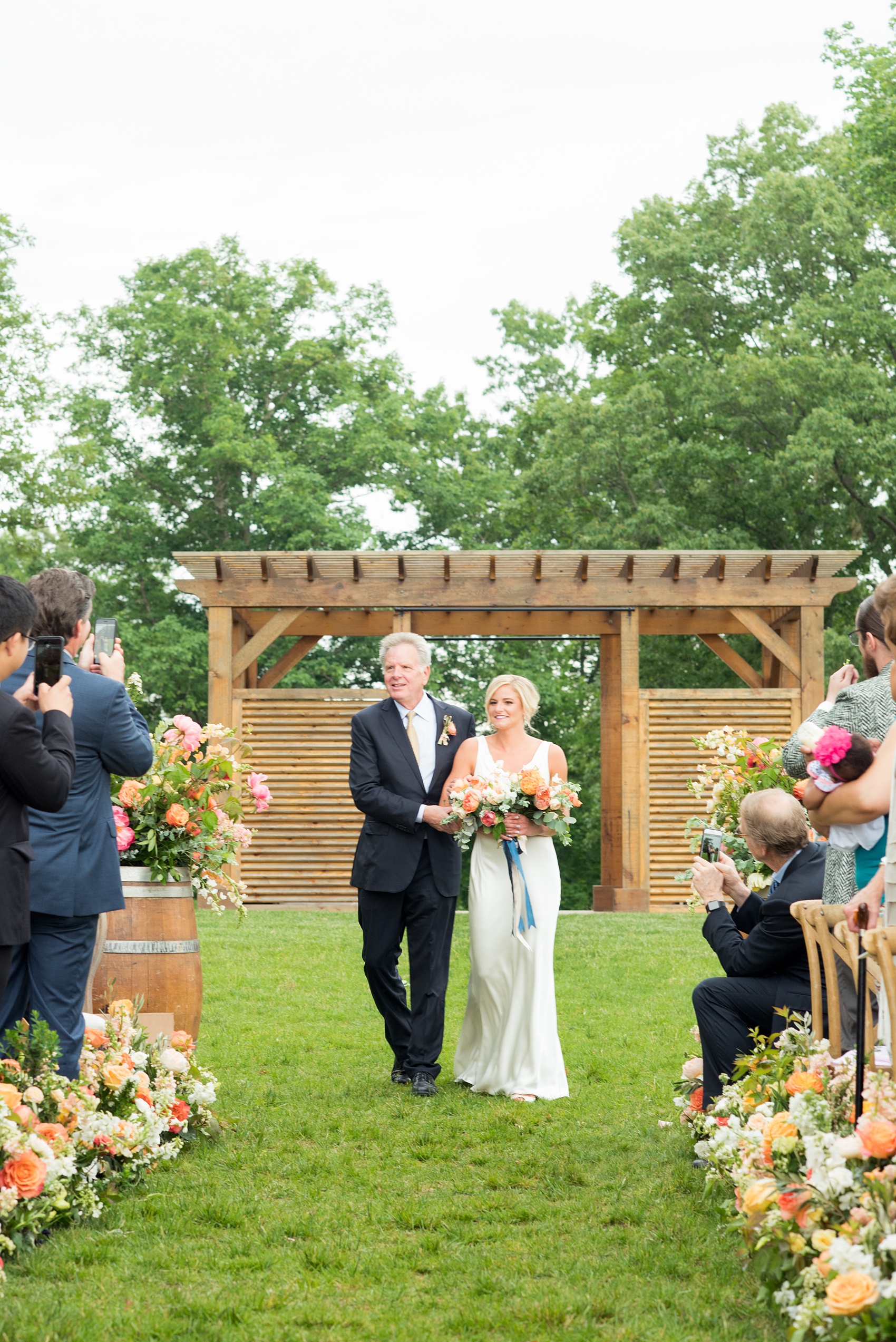 Charlottesville wedding photos by Mikkel Paige Photography at the Lodge at Mount Ida Farm. This Virginia venue is perfect for brides and grooms looking for a beautiful farm reception space. It’s green, romantic, and easy to dress up with flowers or keep simple! The ceremony was held outdoors on the hill, overlooking the Blue Ridge Mountains. Click through for the complete post from this May event, especially details of the flower-lined aisle! Planning and design by @vivalevent and flowers by @apassarelli of Meristem Floral. #Charlottesville #mountidafarm #lodgeatmountida #CharlottesvilleVA #CharlottesvilleVirginia #Charlottesvillewedding #Charlottesvilleweddingphotographer #mikkelpaige #MeristemFloral #VivaLEvent #outdoorceremony #blueridgemountains