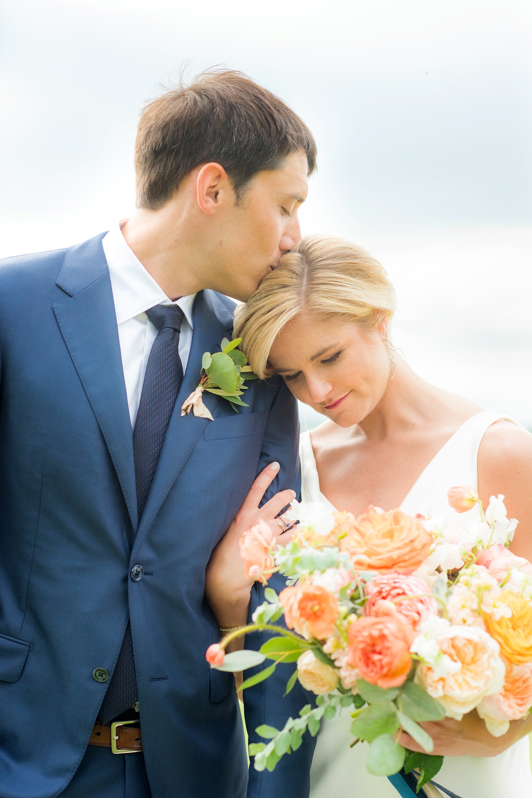 Charlottesville wedding photos by Mikkel Paige Photography. This Virginia venue is perfect for brides and grooms looking for a beautiful farm reception space. It’s green, romantic, and easy to dress up with flowers or keep simple! The bride wore a gorgeous, sexy back cowl neck silk gown by Suzanne Neville and wore her hair in an up-do. The groom wore a navy blue suit and tie and wore a succulent and eucalyptus boutonnière. The bride’s colorful rose, peony and ranunculus bouquet was also dotted with succulents and tied with silk ribbons. Click through for the complete post from this May event at the Lodge at Mount Ida Farm! Planning and design by @vivalevent. #Charlottesville #mountidafarm #lodgeatmountida #CharlottesvilleVA #CharlottesvilleVirginia #Charlottesvillewedding #Charlottesvilleweddingphotographer #mikkelpaige #Vivalevent #brideandgroom #navybluesuit #sexybackweddinggown #backlessweddinggown #suzanneneville #TraditionsbyAnna #WinkHairandMakeup