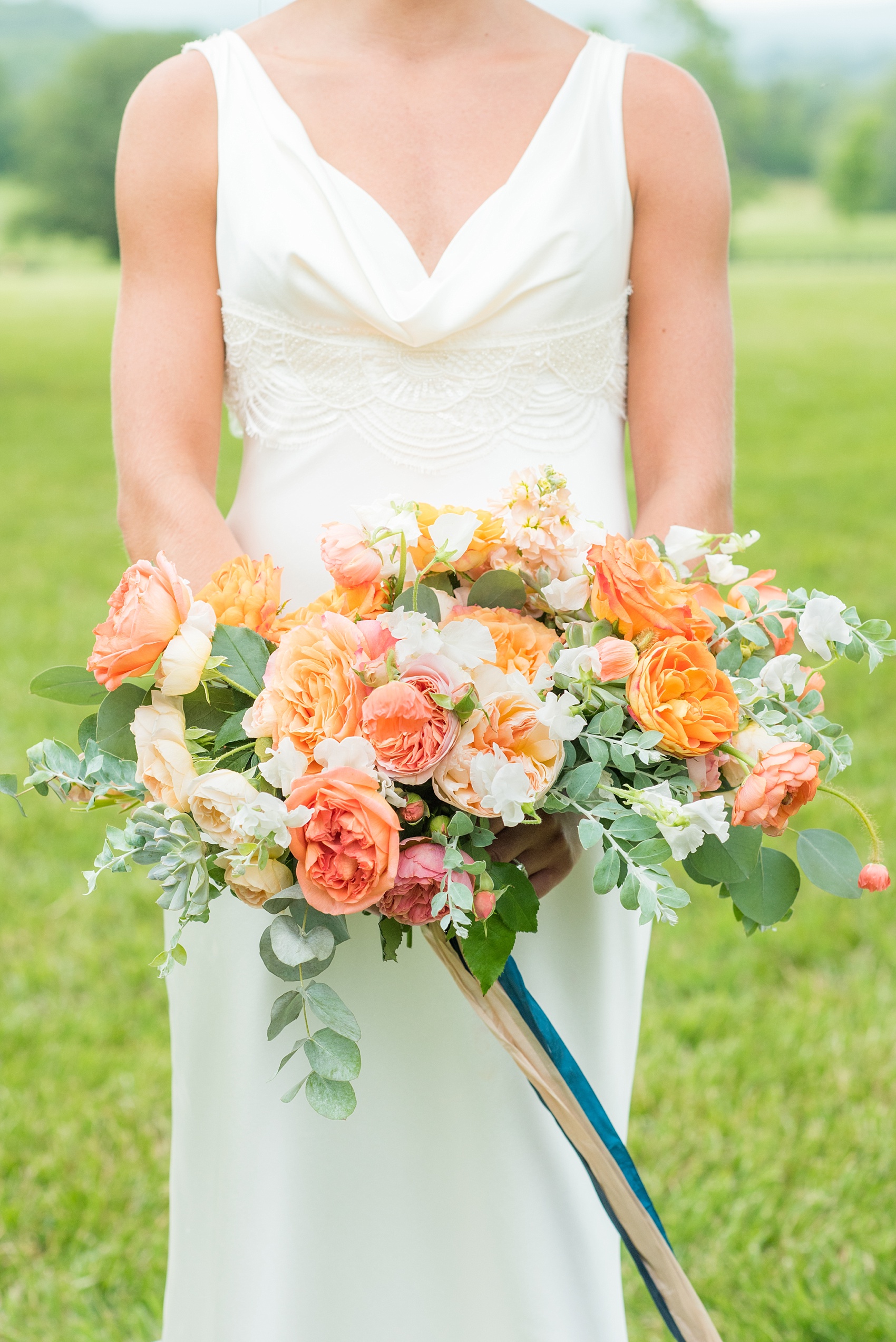 Charlottesville wedding photos by Mikkel Paige Photography. This Virginia venue is perfect for brides and grooms looking for a beautiful farm reception space. It’s green, romantic, and easy to dress up with flowers or keep simple. The bouquets were tied with long navy blue, peach and light pink ribbons and contained colorful flowers like garden roses, peonies, ranunculus and succulents. Click through for the complete post from this May event at the Lodge at Mount Ida Farm! Planning and design by @vivalevent and flowers by @apassarelli of Meristem Floral. #Charlottesville #mountidafarm #lodgeatmountida #CharlottesvilleVA #CharlottesvilleVirginia #Charlottesvillewedding #Charlottesvilleweddingphotographer #mikkelpaige #MeristemFloral #VivaLEvent