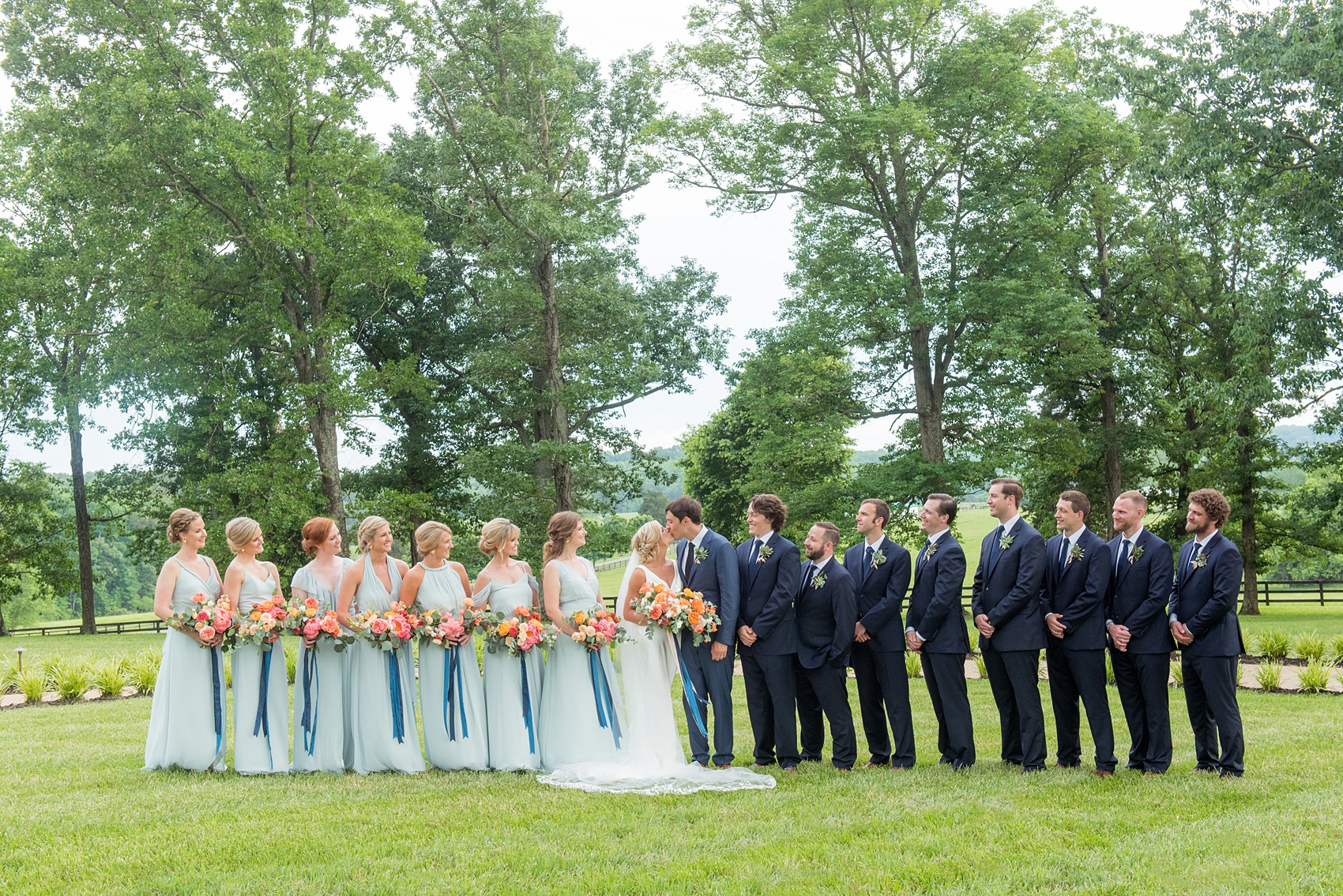 Charlottesville wedding photos by Mikkel Paige Photography at the Lodge at Mount Ida Farm. This Virginia venue is perfect for brides and grooms looking for a beautiful farm reception space. It’s green, romantic, and easy to dress up with flowers or keep simple! The wedding party looked elegant with the groomsmen in navy blue suits, succulent boutonnieres, and bridesmaids wore mismatched mint green gowns with colorful bouquets. Click through for the complete post from this May event! Planning by @vivalevent and flowers by @apassarelli of Meristem Floral. #Charlottesville #mountidafarm #lodgeatmountida #CharlottesvilleVA #CharlottesvilleVirginia #Charlottesvillewedding #Charlottesvilleweddingphotographer #mikkelpaige #MeristemFloral #VivaLEvent