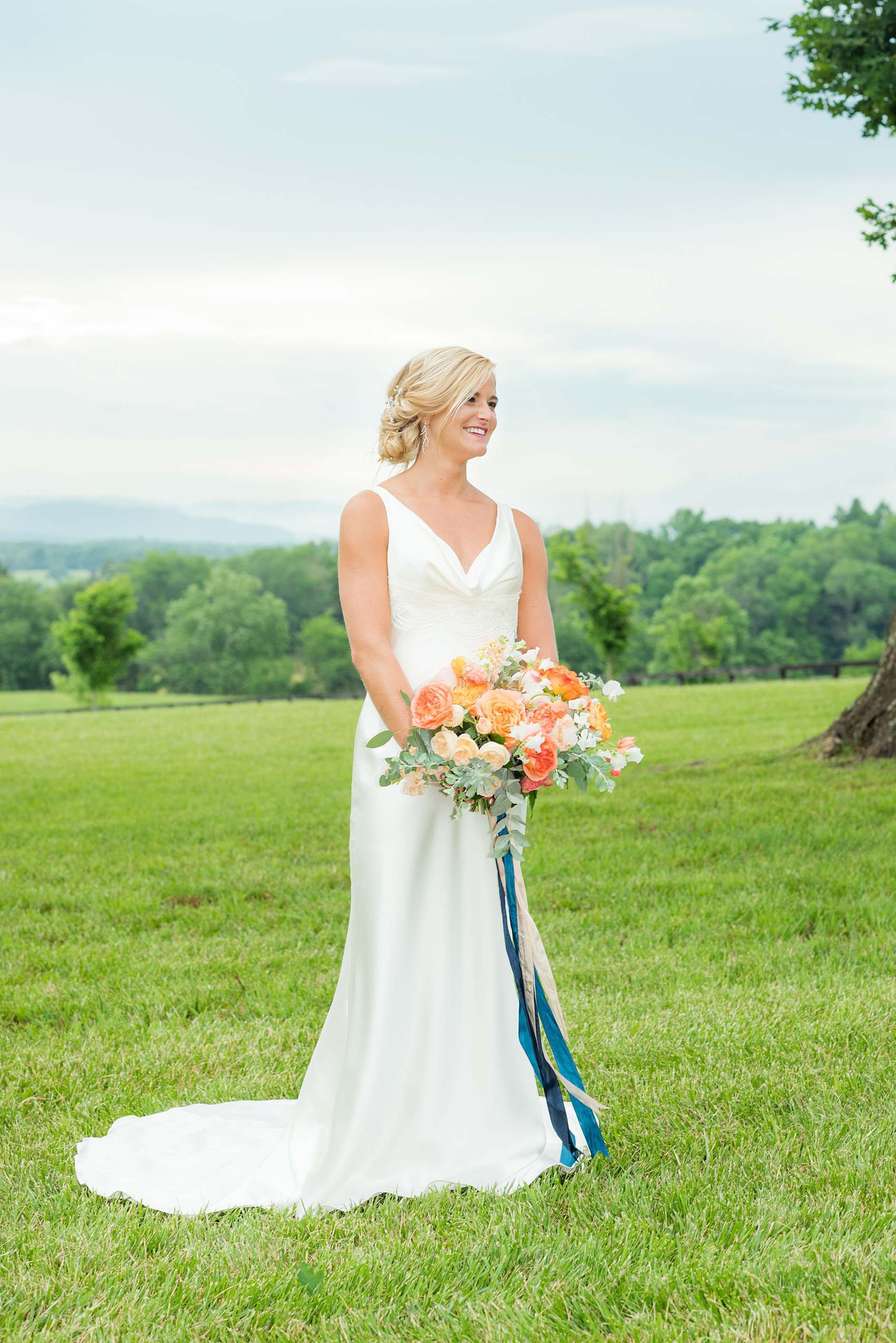 Charlottesville wedding photos by Mikkel Paige Photography. This Virginia venue is perfect for brides and grooms looking for a beautiful farm reception space. The bride wore a sexy, sleek open-back Suzanne Neville gown from Traditions by Anna and carried a bouquet of colorful flowers by Meristem Floral. Her hair was pulled up and makeup done by Wink Hair and Makeup. This green, romantic venue is easy to dress up with flowers or keep simple! Click through for the complete post from this May event at the Lodge at Mount Ida Farm! Planning and design by @vivalevent. #Charlottesville #mountidafarm #lodgeatmountida #CharlottesvilleVA #CharlottesvilleVirginia #Charlottesvillewedding #Charlottesvilleweddingphotographer #mikkelpaige #Vivalevent #herecomesthebride #bridalportraits #bridalphotos 