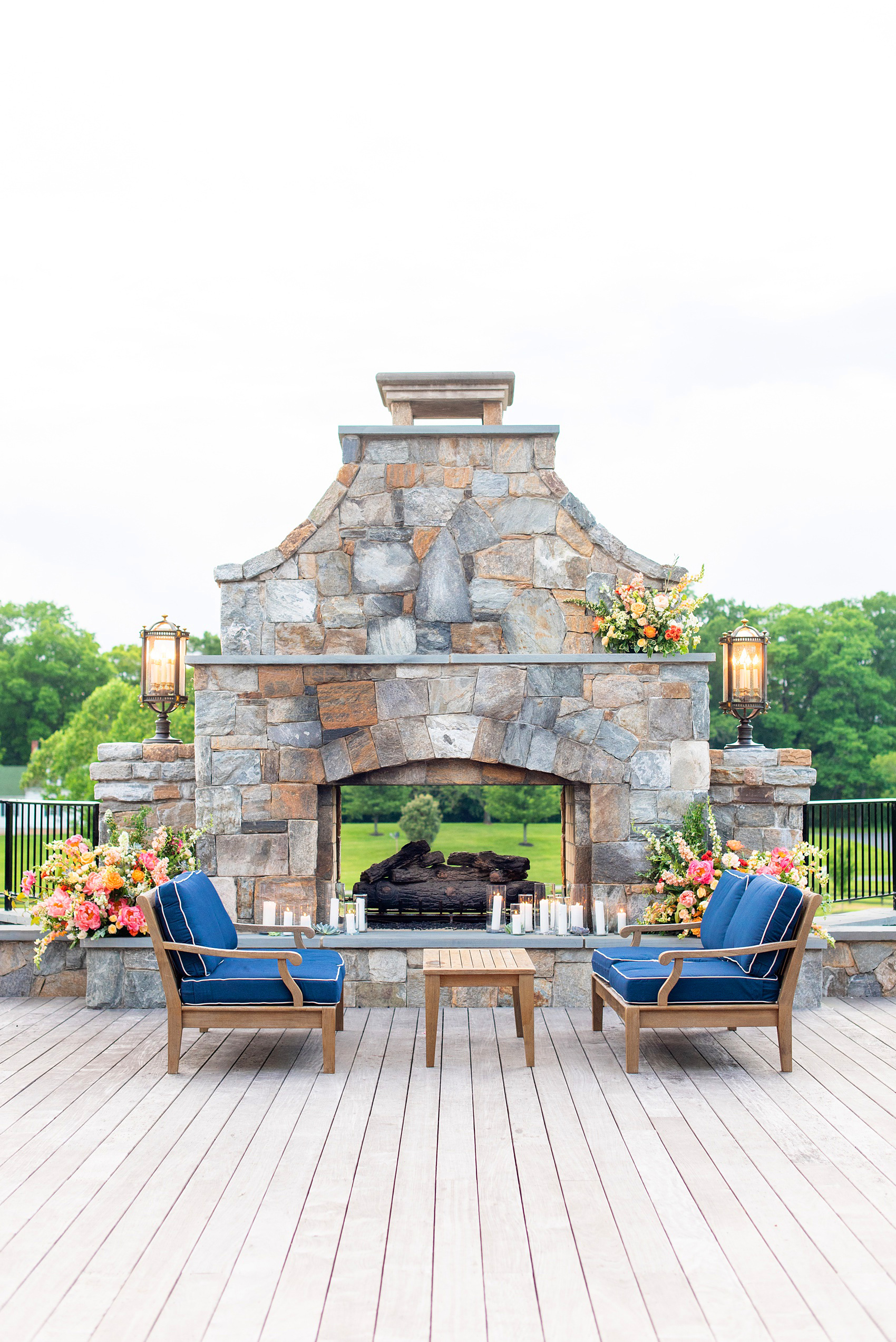 Charlottesville wedding photos at the Lodge at Mount Ida Farm by Mikkel Paige Photography. This Virginia venue is perfect for brides and grooms looking for a beautiful farm reception space. It’s green, romantic, and easy to dress up with flowers or keep simple. The outdoor fireplace was decorated with candles and beautiful flower arrangements by @apassarelli of Meristem Floral. Click through for the complete post and detail pictures from this May event! #Charlottesville #mountidafarm #lodgeatmountida #CharlottesvilleVA #CharlottesvilleVirginia #Charlottesvillewedding #Charlottesvilleweddingphotographer #mikkelpaige #VivaLEvent #MeristemFloral #outdoorweddingspace 