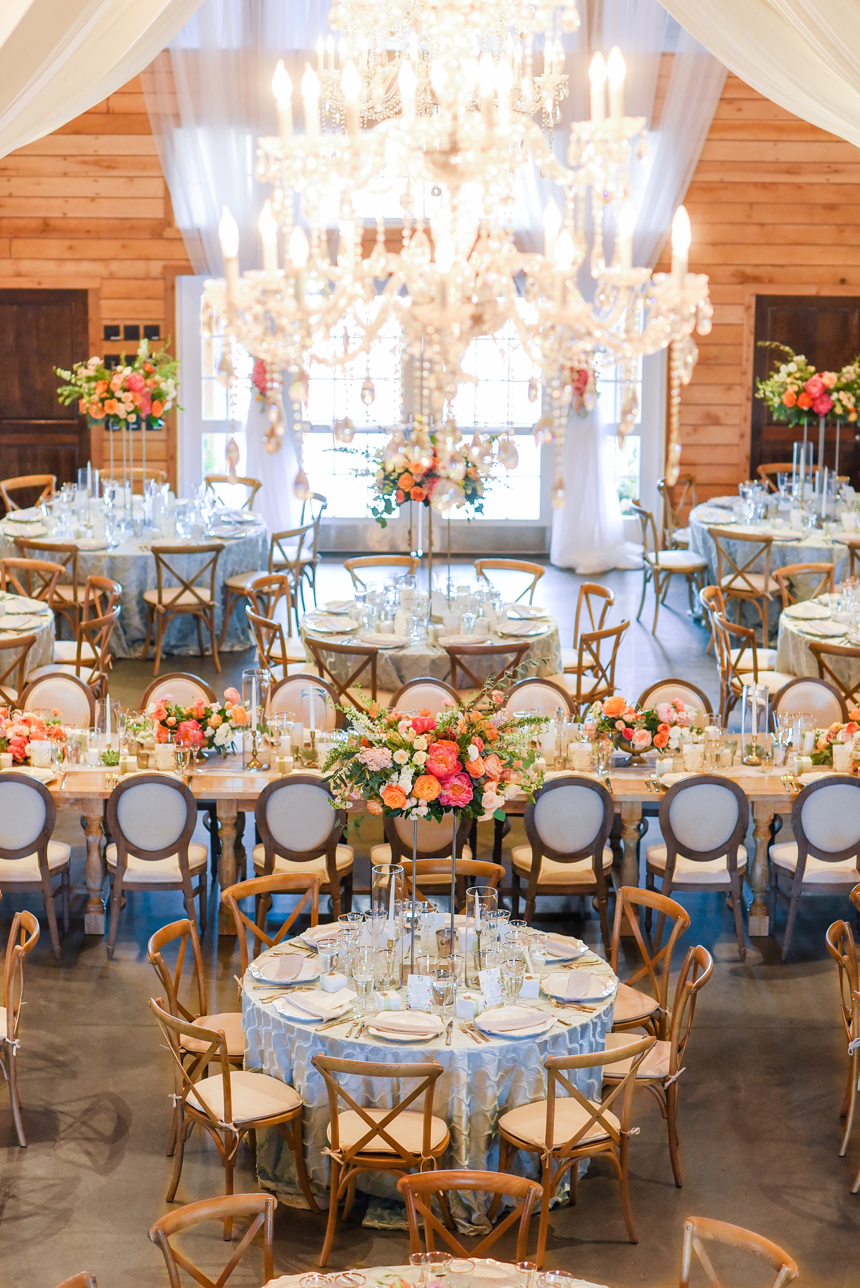 Charlottesville wedding photos by Mikkel Paige Photography. This Virginia venue is perfect for brides and grooms looking for a beautiful farm reception space. It’s green, romantic, and easy to dress up with flowers or keep simple. A rustic and elegant came to life at the reception barn with chandeliers, fabric draping, mixed rectangular farm tables and round luxurious linen-covered round tables inside the venue. Tall and short centerpieces with colorful flowers like garden roses, peonies, ranunculus and succulents completed the tables. Click through for the complete post from this May event at the Lodge at Mount Ida Farm! Planning and design by @vivalevent and flowers by @apassarelli of Meristem Floral. #Charlottesville #mountidafarm #lodgeatmountida #CharlottesvilleVA #CharlottesvilleVirginia #Charlottesvillewedding #Charlottesvilleweddingphotographer #mikkelpaige #MeristemFloral #VivaLEvent