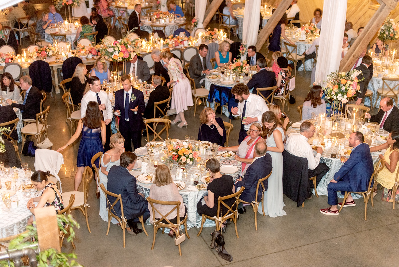 Charlottesville wedding photos by Mikkel Paige Photography. This Virginia venue is perfect for brides and grooms looking for a beautiful farm reception space. It’s green, romantic, and easy to dress up with flowers or keep simple. A rustic and elegant came to life at the reception barn with chandeliers, fabric draping, mixed rectangular farm tables and round luxurious linen-covered round tables inside the venue. Tall and short centerpieces with colorful flowers like garden roses, peonies, ranunculus and succulents completed the tables. Click through for the complete post from this May event at the Lodge at Mount Ida Farm! Planning and design by @vivalevent and flowers by @apassarelli of Meristem Floral. #Charlottesville #mountidafarm #lodgeatmountida #CharlottesvilleVA #CharlottesvilleVirginia #Charlottesvillewedding #Charlottesvilleweddingphotographer #mikkelpaige #MeristemFloral #VivaLEvent