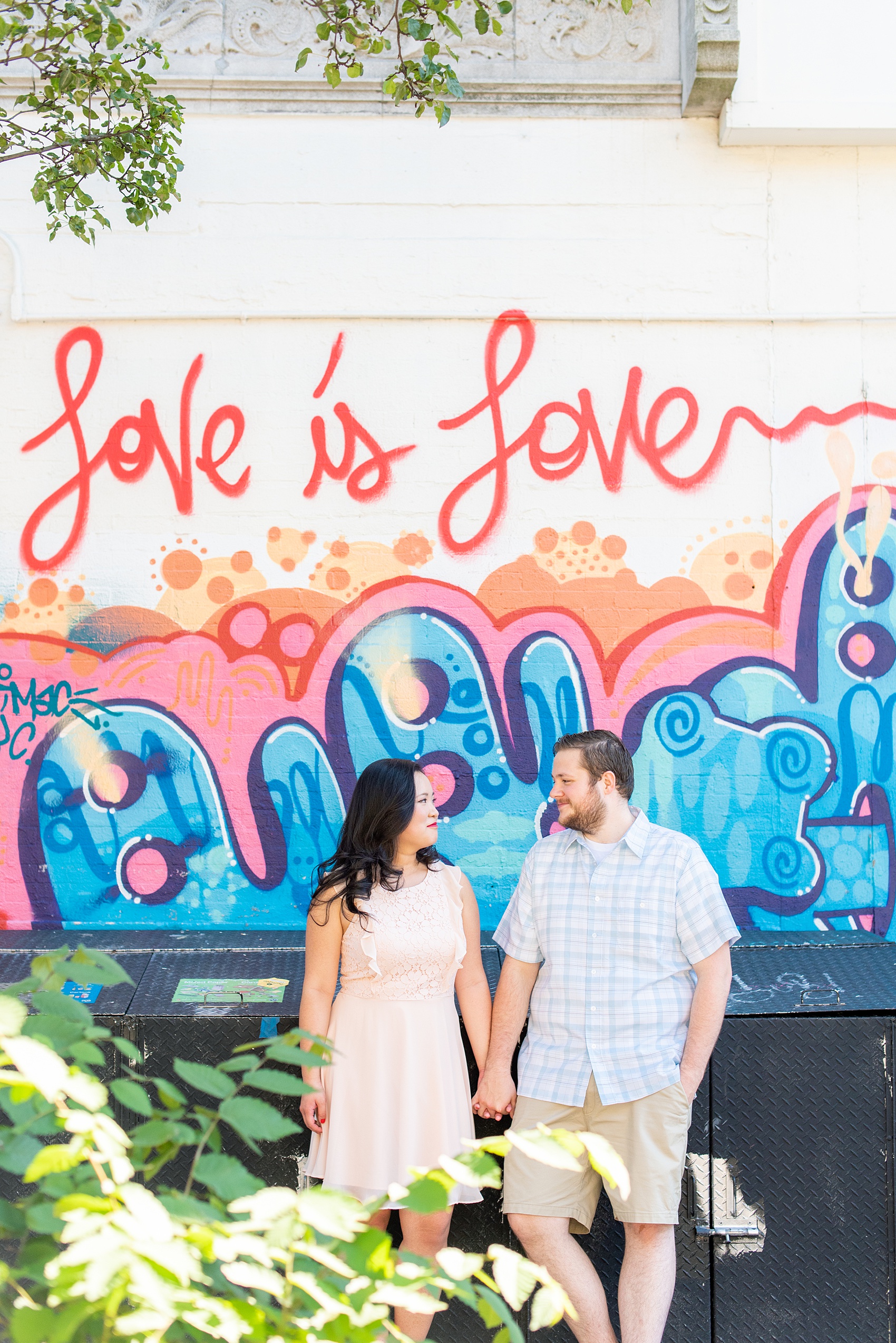 Engagement photos and colorful ideas for a shoot in the Lower East Side by Mikkel Paige Photography. These creative pictures with an interracial couple in an urban environment in downtown NYC will have you wanting to see more...so be sure to click through to see the entire shoot! #mikkelpaige #EngagementPhotos #engagementshoot #EngagementPictures