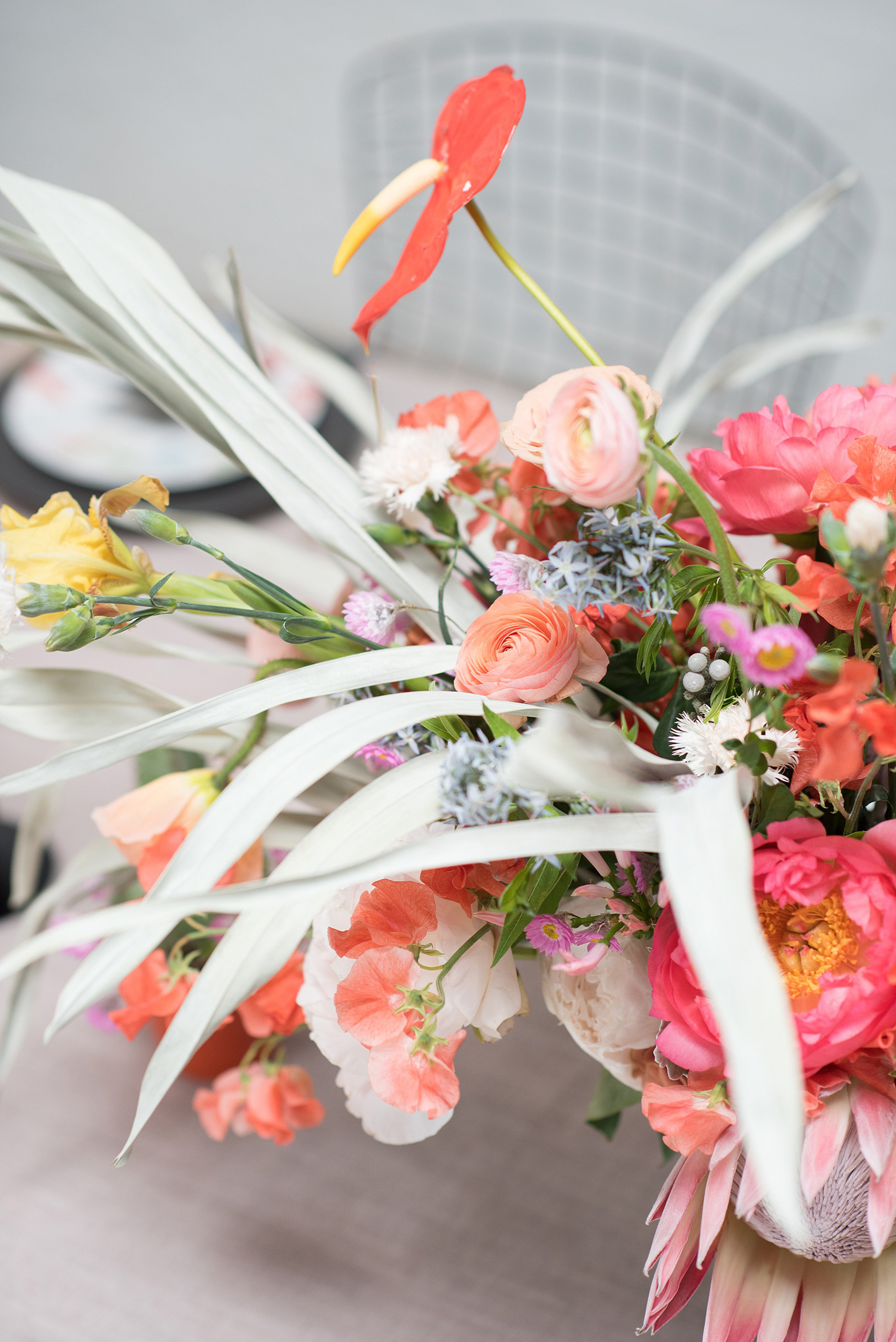 Palm Springs inspired wedding ideas with photos by Mikkel Paige Photography, NYC photographer. The pictures of this beautiful, tropical floral centerpiece in a black vase was created by Sachi Rose Designs. Planning by Color Pop Events for a shoot with Love Inc. Mag. #PalmSpringsInspiration #PalmSpringsWedding #Midcenturymodern