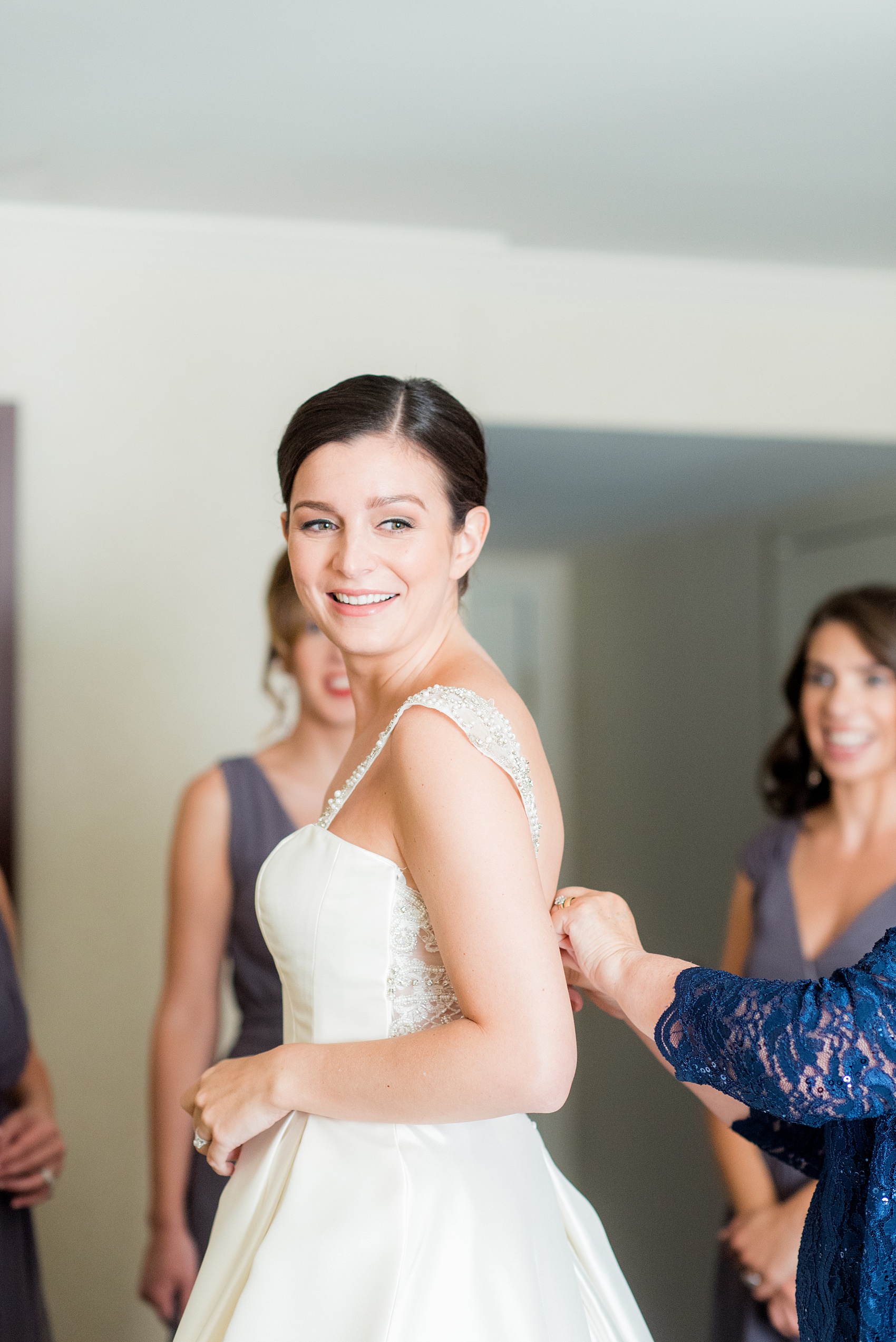 Mikkel Paige Photography pictures of a venue in Durham, North Carolina. The Washington Duke Inn is perfect for a summer wedding! Planning for this beautiful event was by McLean Events. The bride got ready for her wedding day surrounded by her bridesmaids and mother in a hotel room onsite. Click through for more details about this June wedding with peonies! #MikkelPaige #DurhamWeddings #WashingtonDukeInn #DukeWedding #Duke #McLeanEvents #blueandwhitewedding #bride #gettingready