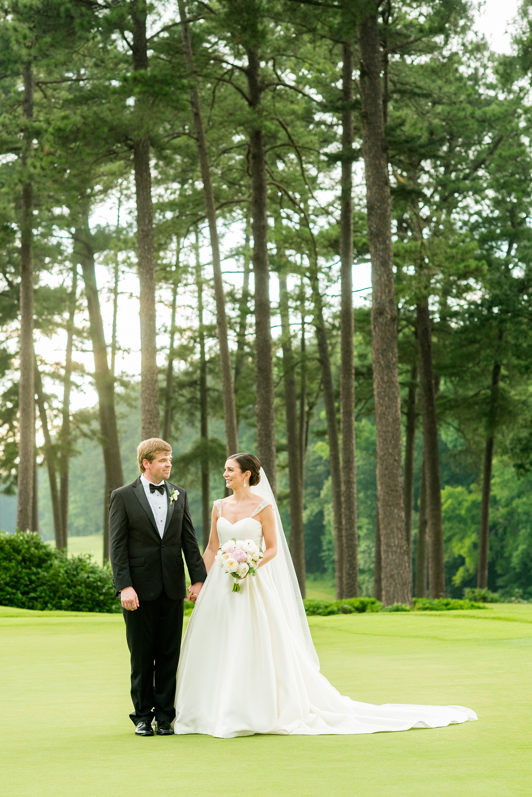 Mikkel Paige Photography pictures of a venue in Durham, North Carolina. The Washington Duke Inn is perfect for a summer wedding! Planning for this beautiful event was by McLean Events. The bride and groom had their pictures taken on the picturesque golf course during golden hour. Click through for more details about this June wedding with peonies! #MikkelPaige #DurhamWeddings #WashingtonDukeInn #DukeWedding #Duke #McLeanEvents #blueandwhitewedding #golfcoursewedding #golfcoursephotos #brideandgroom