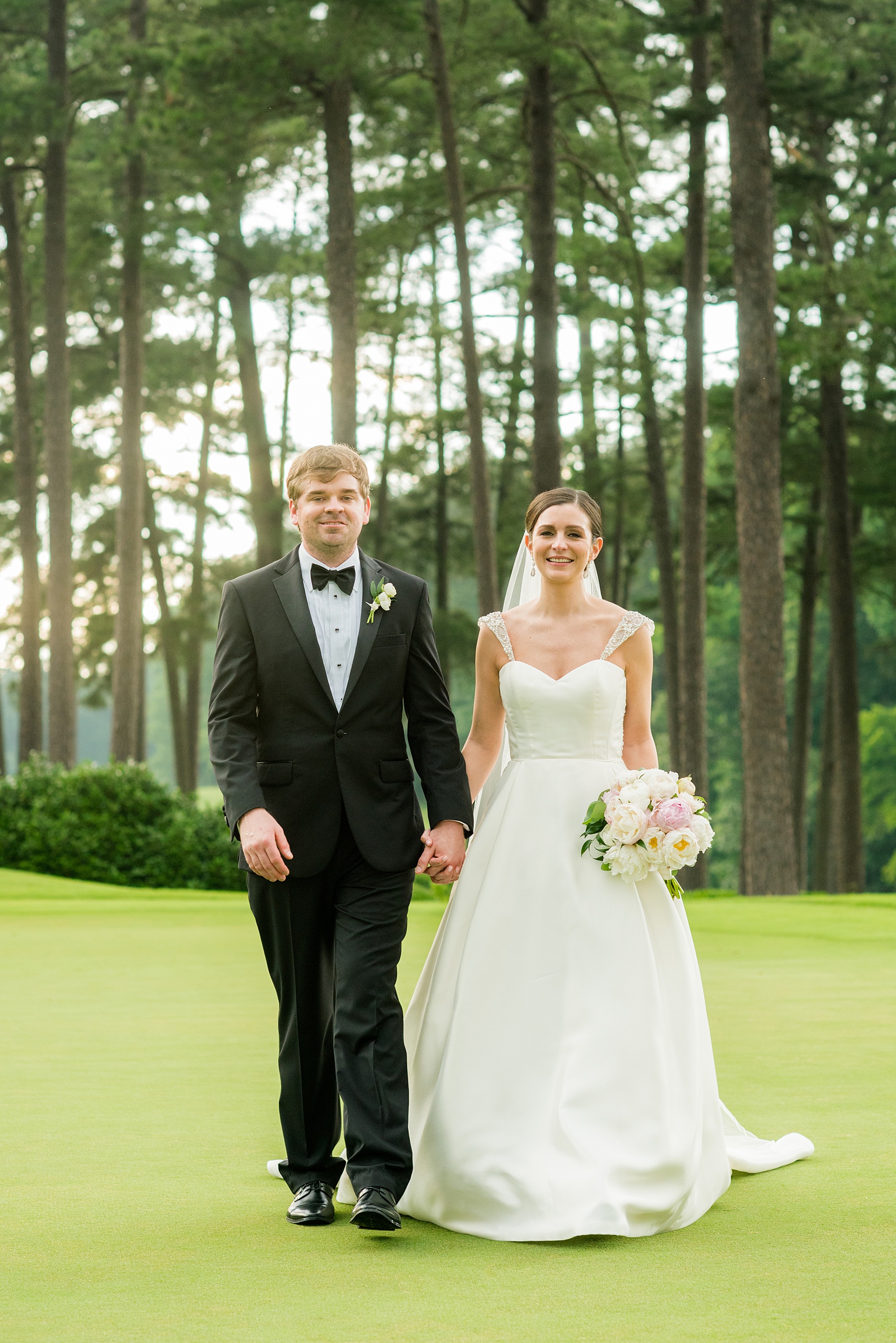 Mikkel Paige Photography pictures of a venue in Durham, North Carolina. The Washington Duke Inn is perfect for a summer wedding! Planning for this beautiful event was by McLean Events. The bride and groom had their pictures taken on the picturesque golf course during golden hour. The back of the bride's gown was incredible and had intricate beading behind her white veil. Hair and Makeup was done by Wink. Click through for more details about this June wedding with peonies! #MikkelPaige #DurhamWeddings #WashingtonDukeInn #DukeWedding #Duke #McLeanEvents #blueandwhitewedding #golfcoursewedding #golfcoursephotos #brideandgroom #winkhairandmakeup