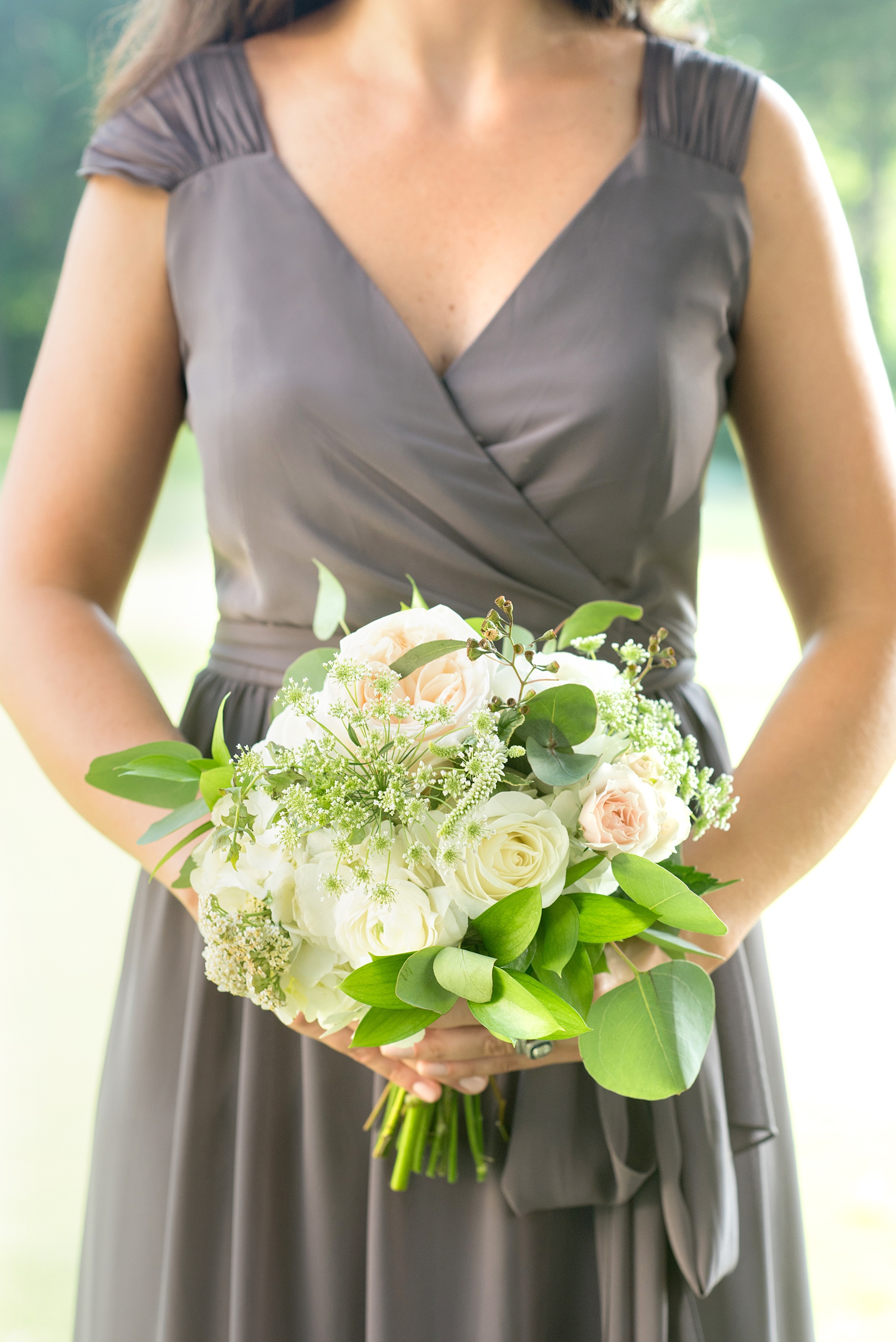 Mikkel Paige Photography pictures of a venue in Durham, North Carolina. The Washington Duke Inn is perfect for a summer wedding! Planning for this beautiful event was by McLean Events. The bridesmaids carried bouquets with Queen Anne's lace, pink Astilbe, roses and greenery. They wore grey chiffon gowns with beauty by Wink Hair and Makeup. Click through for more details about this June wedding with peonies! #MikkelPaige #DurhamWeddings #WashingtonDukeInn #DukeWedding #Duke #McLeanEvents #blueandwhitewedding #golfcoursewedding #golfcoursephotos #bridalparty #weddingparty #greybridesmaids #peonybouquet #queenanneslace