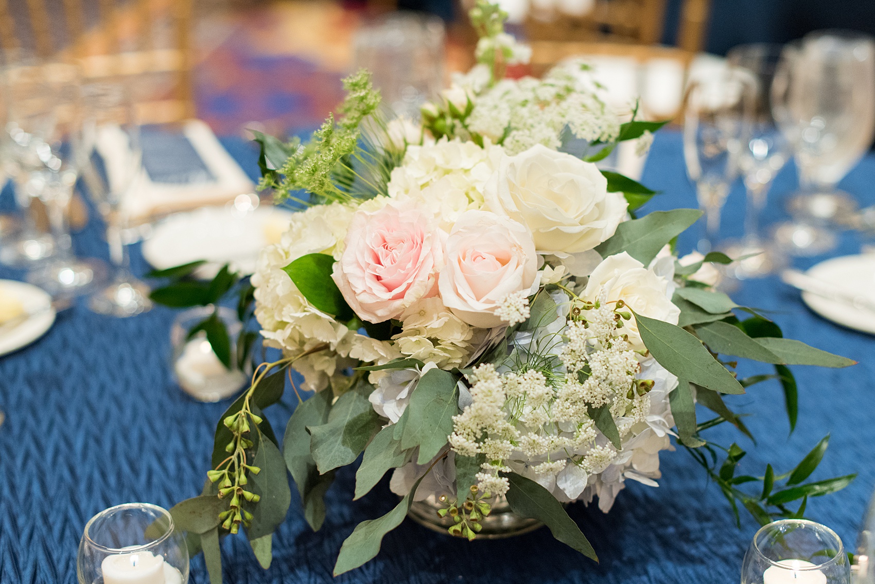 Mikkel Paige Photography pictures of a venue in Durham, North Carolina. The Washington Duke Inn is perfect for a summer wedding! Planning for this beautiful event was by McLean Events. The indoor reception had high and low flowers by English Garden Raleigh and blue linens from CE Rental. Click through for more details about this June wedding with peonies! #MikkelPaige #DurhamWeddings #WashingtonDukeInn #DukeWedding #Duke #McLeanEvents #blueandwhitewedding #golfcoursewedding #bluereception #indoorreception