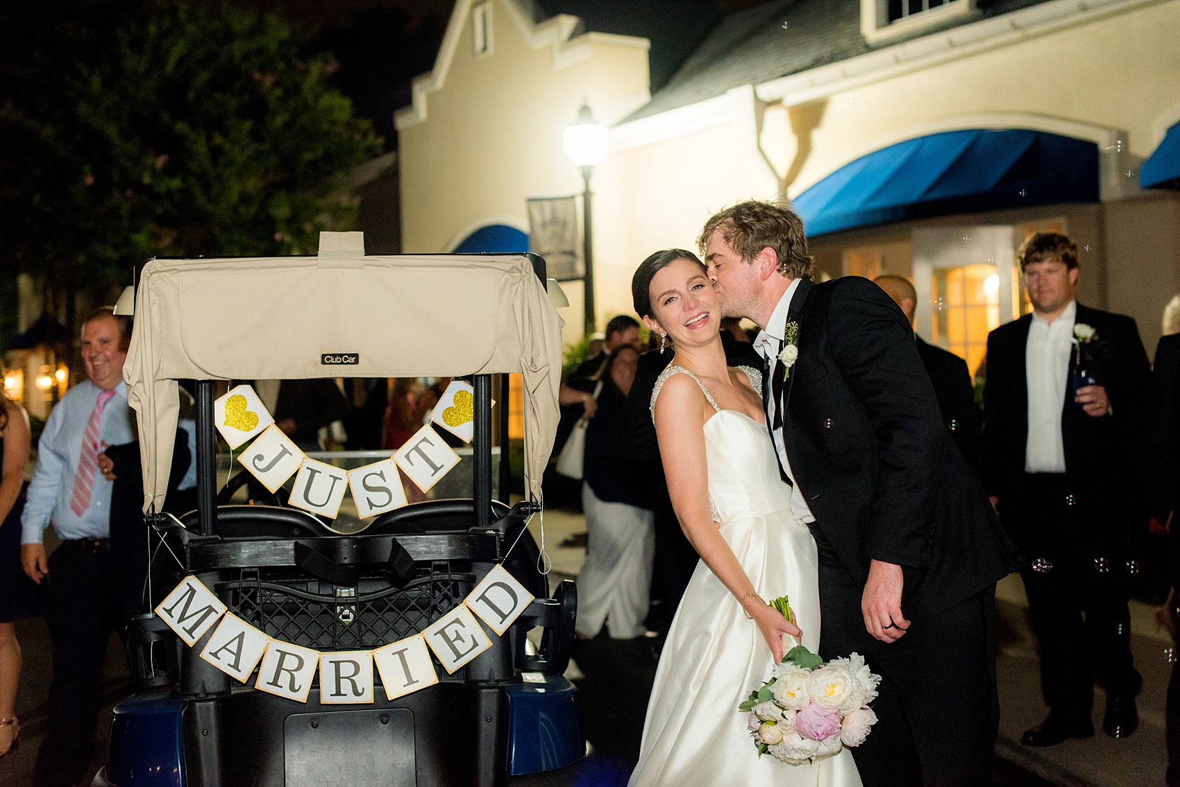 Mikkel Paige Photography pictures of a venue in Durham, North Carolina. The Washington Duke Inn is perfect for a summer wedding! Planning for this beautiful event was by McLean Events. This bride and groom left the wedding in a golf cart decorated with a "Just Married" sign after a bubble exit. Click through for more details about this June wedding with peonies! #MikkelPaige #DurhamWeddings #WashingtonDukeInn #DukeWedding #Duke #McLeanEvents #blueandwhitewedding #golfcoursewedding #getawaycar #golfcart #justmarried #bubbleexit