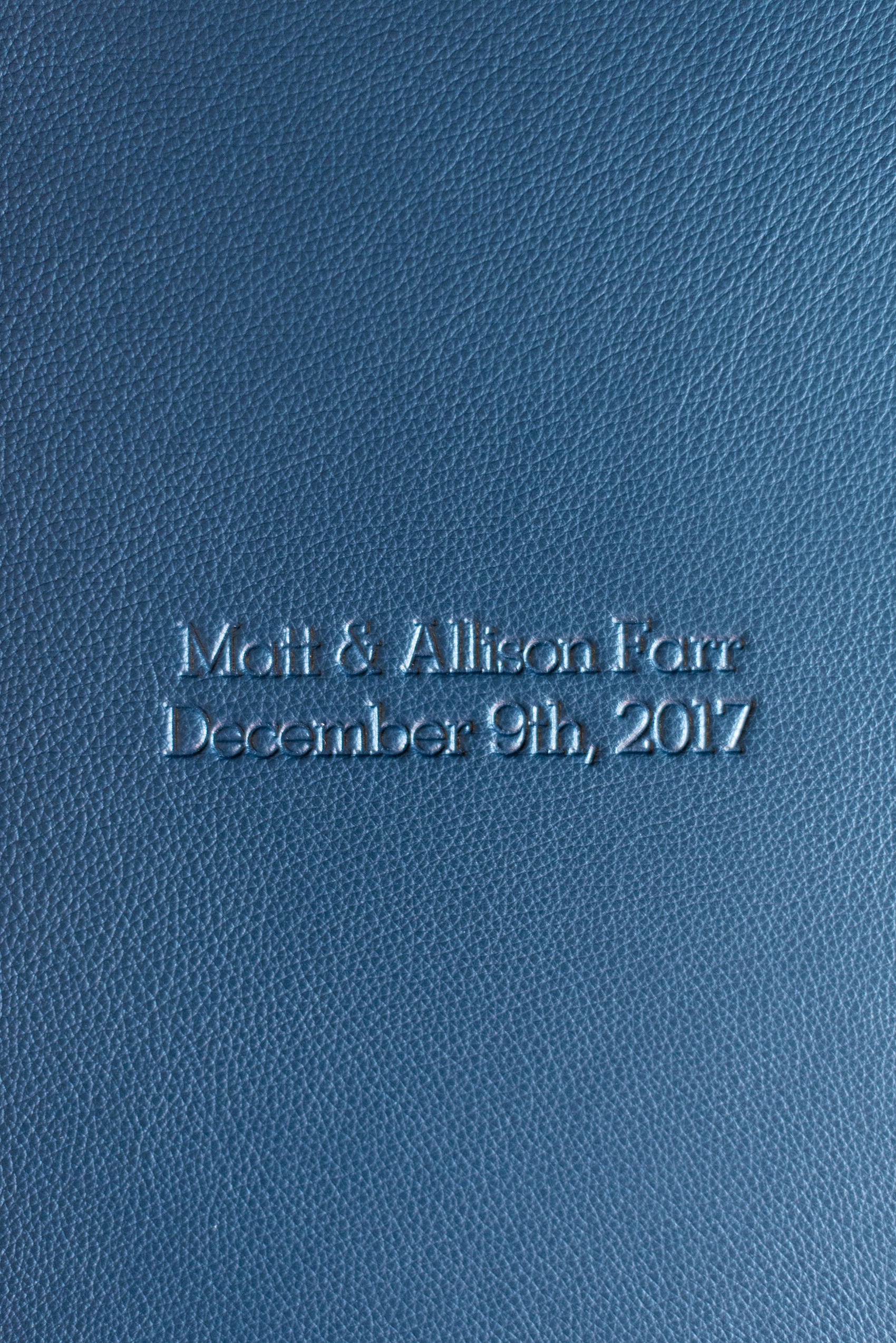 Navy blue leather fine art wedding album from Mikkel Paige Photography, with photos from a snowy winter wedding at The Carolina Inn, in North Carolina. This beatiful, historic venue in Chapel Hill is perfect for outdoor and indoor events no matter if it's spring, summer or fall too. Click through to see more pictures of this couples gorgeous family heirloom keepsakes! #mikkelpaige #carolinainnweddingphotos #carolinainn #leatheralbum #weddingalbum #chapelhill