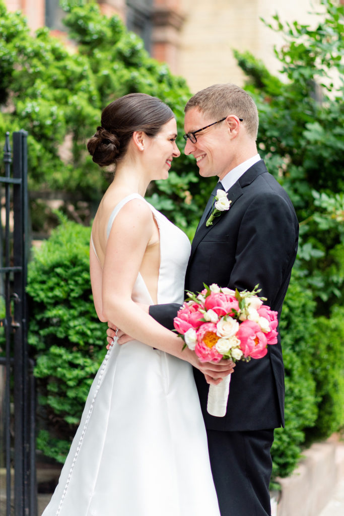 Manhattan Central Park wedding photos by Mikkel Paige Photography at Loeb Boathouse venue. These ceremony and reception pictures show a timeless couple having fun at their colorful day with guests who traveled in from abroad. The bride held a pink peony bouquet for their June celebration and wore a boat-neck gown. Click through for the complete post of images! #CentralParkWeddingVenues #NYCweddingphotographer #NYCwedding #SummerWedding #Peonies #PeonyBouquet #PeoniesBouquet