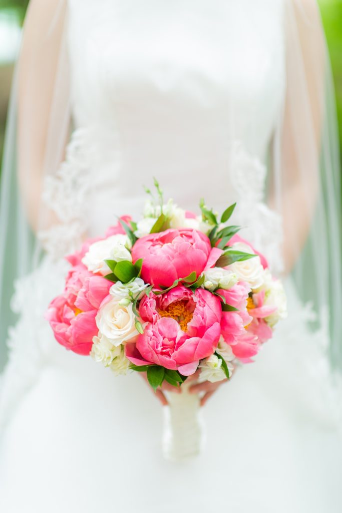 Manhattan Central Park wedding photos by Mikkel Paige Photography at Loeb Boathouse venue. These ceremony and reception pictures show a timeless couple having fun at their colorful day with guests who traveled in from abroad. The bride held a pink and white bouquet of peonies for their June celebration. Click through for the complete post! #CentralParkWeddingVenues #NYCweddingphotographer #NYCwedding #SummerWedding #Peonies #PeonyBouquet #PeoniesBouquet