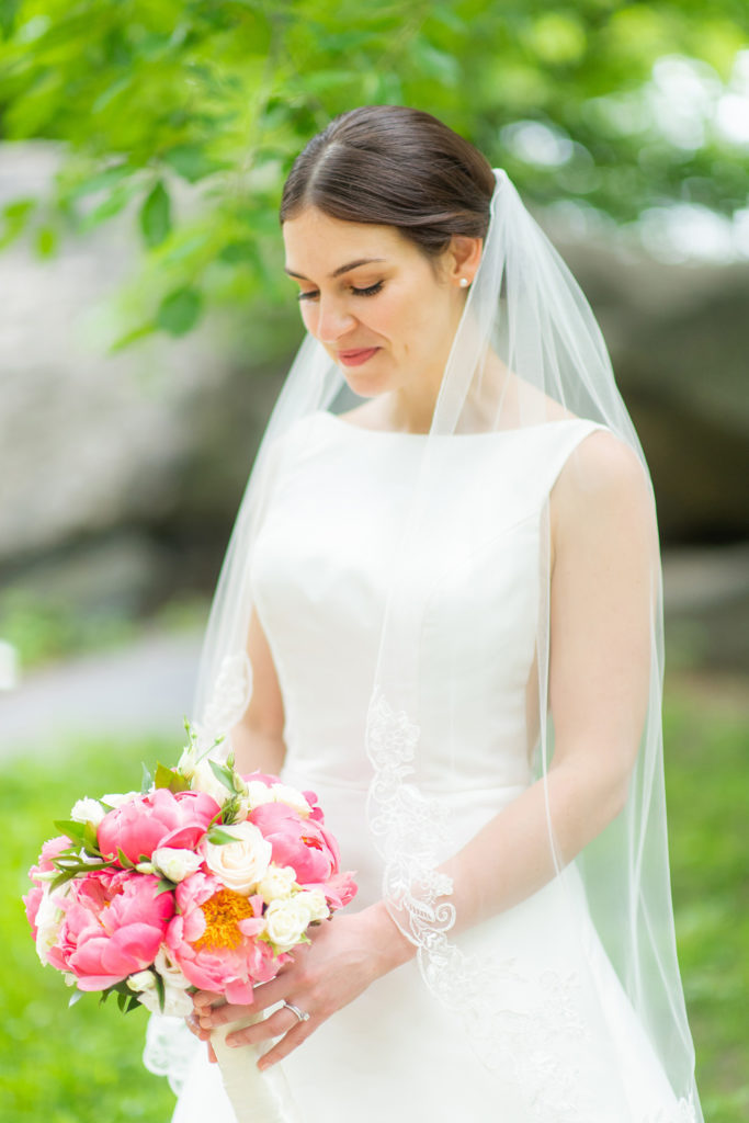 Manhattan Central Park wedding photos by Mikkel Paige Photography at Loeb Boathouse venue. These reception pictures show a timeless couple having fun at their colorful day in this iconic NYC landmark. The bride held a pink and white peonies bouquet for their June celebration and wore a boat-neck gown with buttons down the back. Click through for the complete post! #CentralParkWeddingVenues #NYCweddingphotographer #NYCwedding #SummerWedding #CentralParkPhotos #NYCbride #SotteroandMidgley