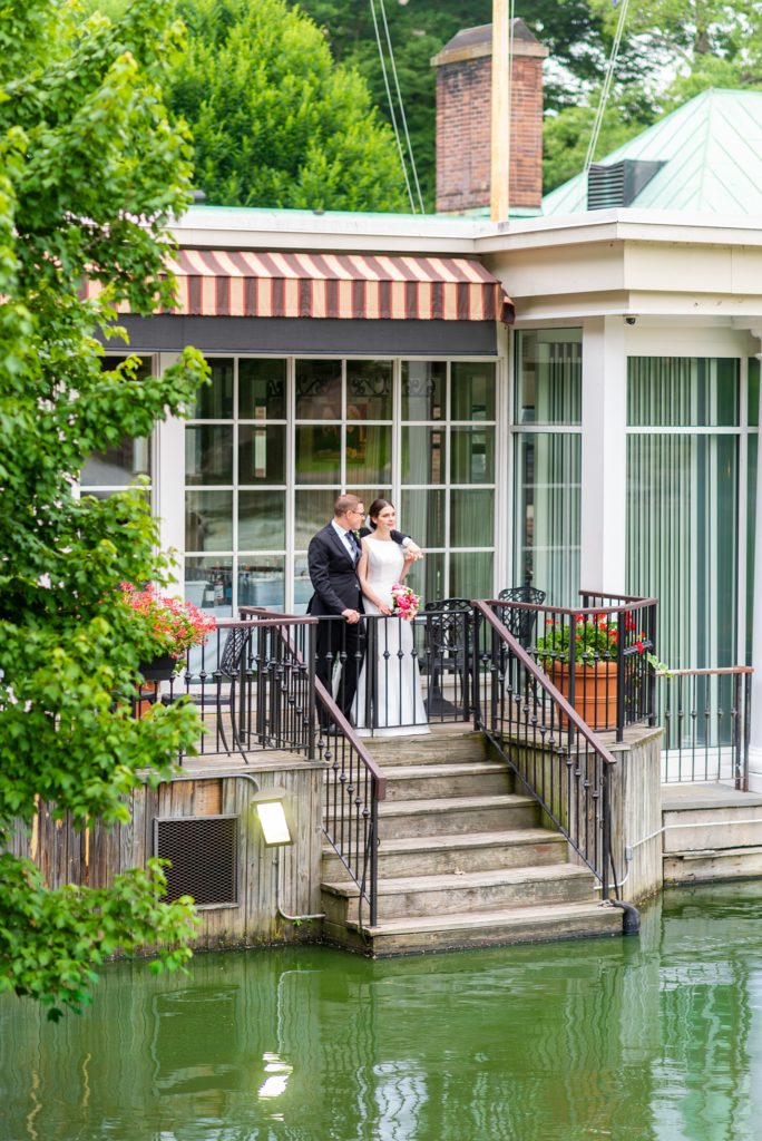 Manhattan Central Park wedding photos by Mikkel Paige Photography at Loeb Boathouse venue. These reception pictures show a timeless couple having fun at their colorful day in this iconic NYC landmark. The bride and groom took photos on the outdoor deck of the venue overlooking the row boat lake that connects to the Bethesda Terrace and fountain area. Click through for the complete post! #CentralParkWeddingVenues #NYCwedding #SummerWedding #CentralParkPhotos #NYbrideandgroom #bethesdafountain