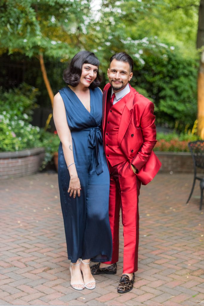 Manhattan Central Park wedding photos by Mikkel Paige Photography at Loeb Boathouse venue. The reception was by the lake and Bethesda Terrace with an outdoor cocktail hour during a June celebration. Guests, who traveled in from near and far, were asked to wear colorful outfits. This red suit and blue silk jumper were a hit! Click through for the complete post! #CentralParkWeddingVenues #NYCwedding #SummerWedding #cocktailhour #weddingguests #weddingdetails #redsuit #weddingguests