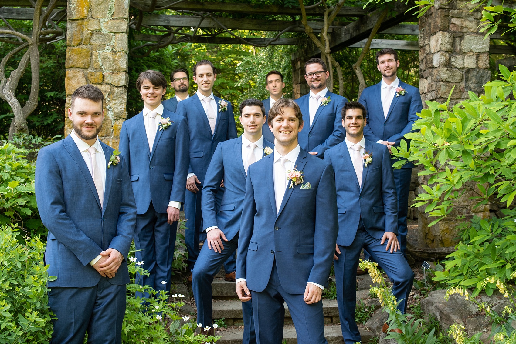 A summer wedding at Olde Mill Inn, NJ. Photos by Mikkel Paige Photography. This New Jersey venue is a great option for an event not too far from NYC. The wedding party photos were at nearby Cross Estate Gardens, a beautiful lush area for bridal party and groomsmen photos. The guys wore blue suits with pink ties. Click through for their complete wedding recap! #OldeMillInn #NJwedding #NJweddingphotographer #mikkelpaige #NewJerseyWeddingVenue #NewJerseyWedding #CrossEstateGardens #weddingdetails #bridalparty #bluesuits #groomsmen