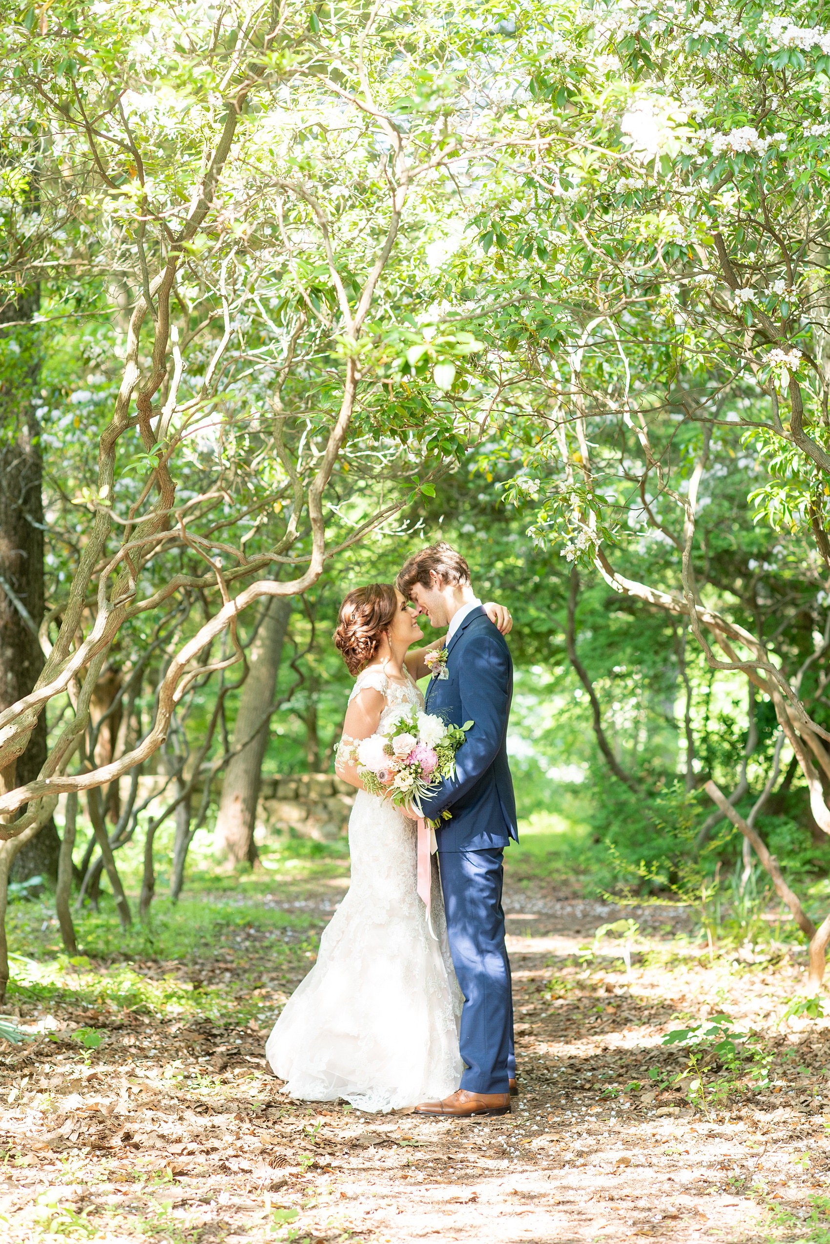 A summer wedding at Olde Mill Inn, NJ. Photos by Mikkel Paige Photography for an event with pink and blue details. The bride and groom chose to have their photos taken at Cross Estate Gardens, just down the road from this New Jersey Venue. Click through for their complete wedding recap! #OldeMillInn #NJwedding #NJweddingphotographer #mikkelpaige #NewJerseyWeddingVenue #NewJerseyWedding #CrossEstateGardens #brideandgroom