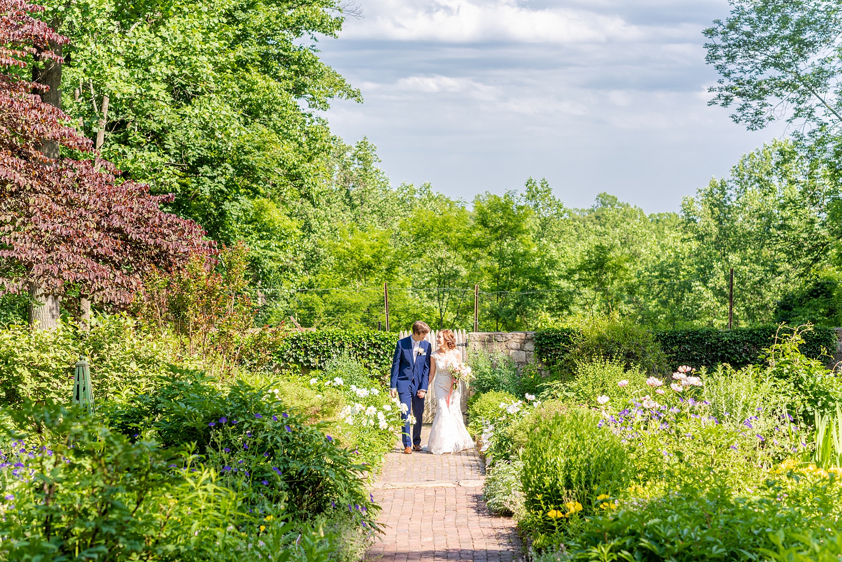 A summer wedding at Olde Mill Inn, NJ. Photos by Mikkel Paige Photography for an event with pink and blue details. The bride and groom chose to have their photos taken at Cross Estate Gardens, just down the road from this New Jersey Venue. Click through for their complete wedding recap! #OldeMillInn #NJwedding #NJweddingphotographer #mikkelpaige #NewJerseyWeddingVenue #NewJerseyWedding #CrossEstateGardens #brideandgroom 