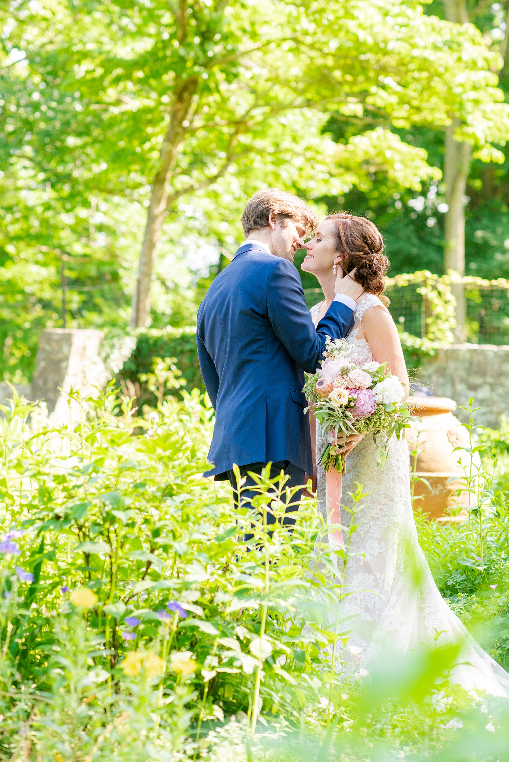 A summer wedding at Olde Mill Inn, NJ. Photos by Mikkel Paige Photography for an event with pink and blue details. The bride and groom chose to have their photos taken at Cross Estate Gardens, just down the road from this New Jersey Venue. Click through for their complete wedding recap! #OldeMillInn #NJwedding #NJweddingphotographer #mikkelpaige #NewJerseyWeddingVenue #NewJerseyWedding #CrossEstateGardens #brideandgroom 